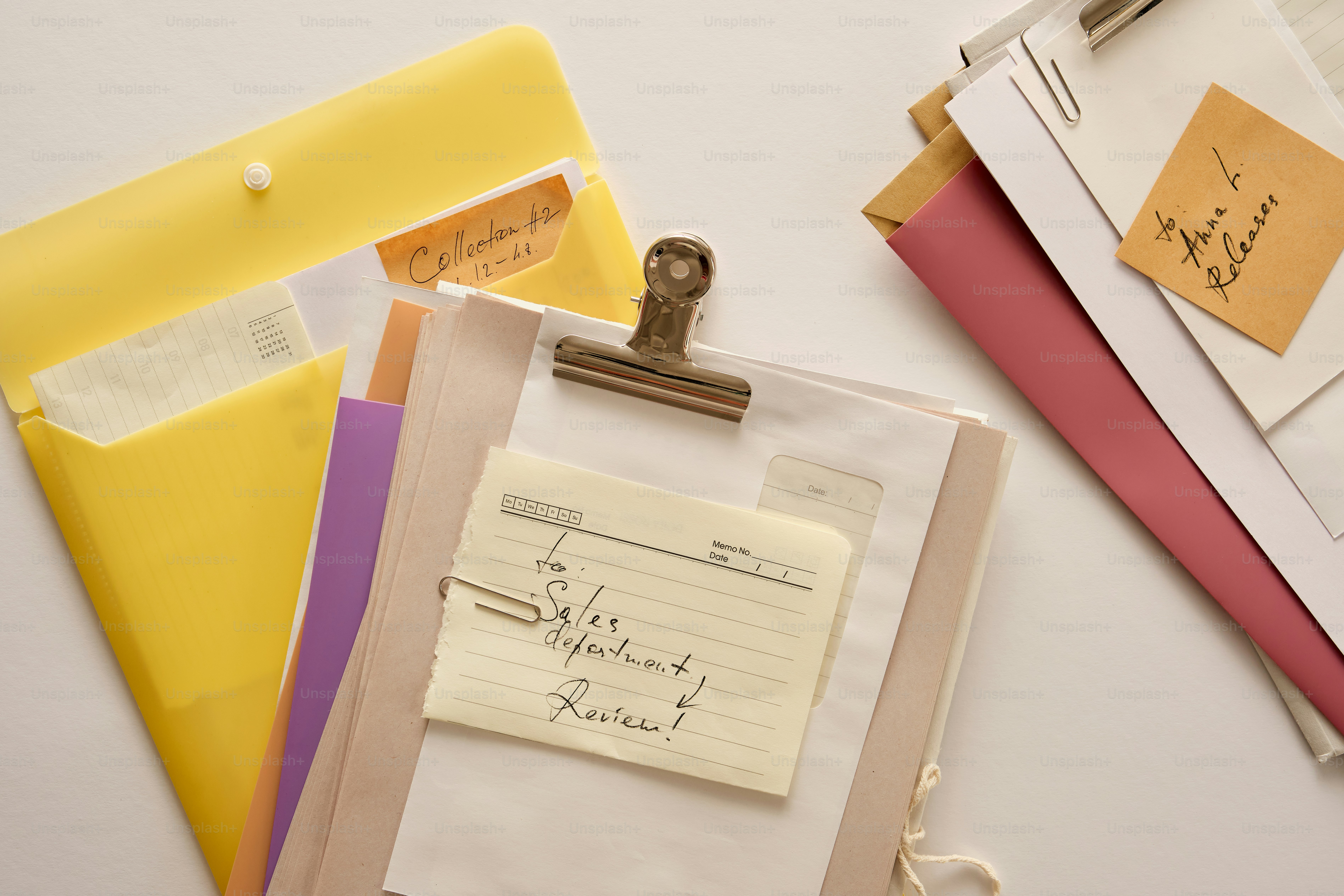 Documents and notes scattered on a white surface. photo – Business ...