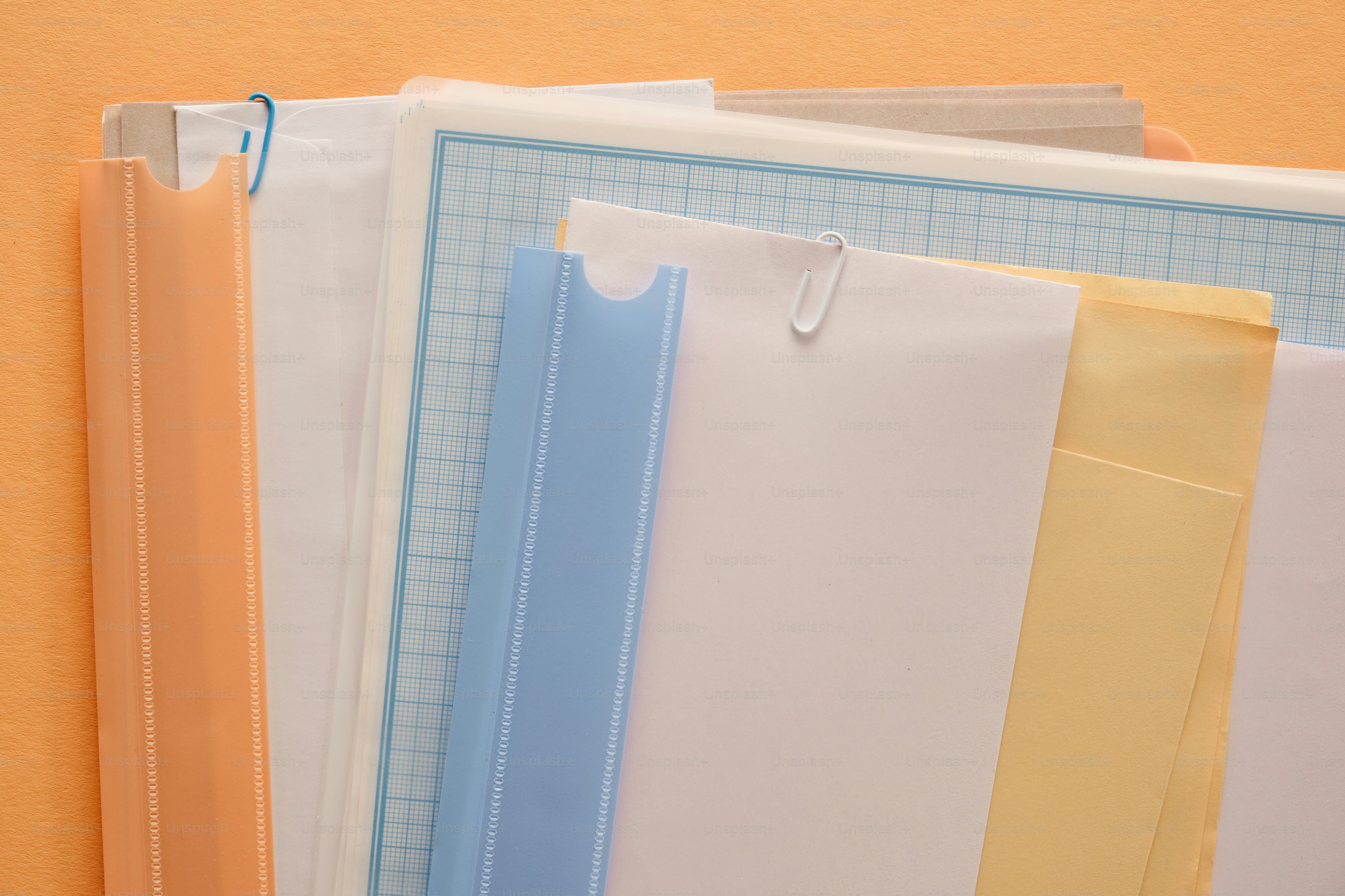 Assortment of colorful document folders on a peach background photo ...
