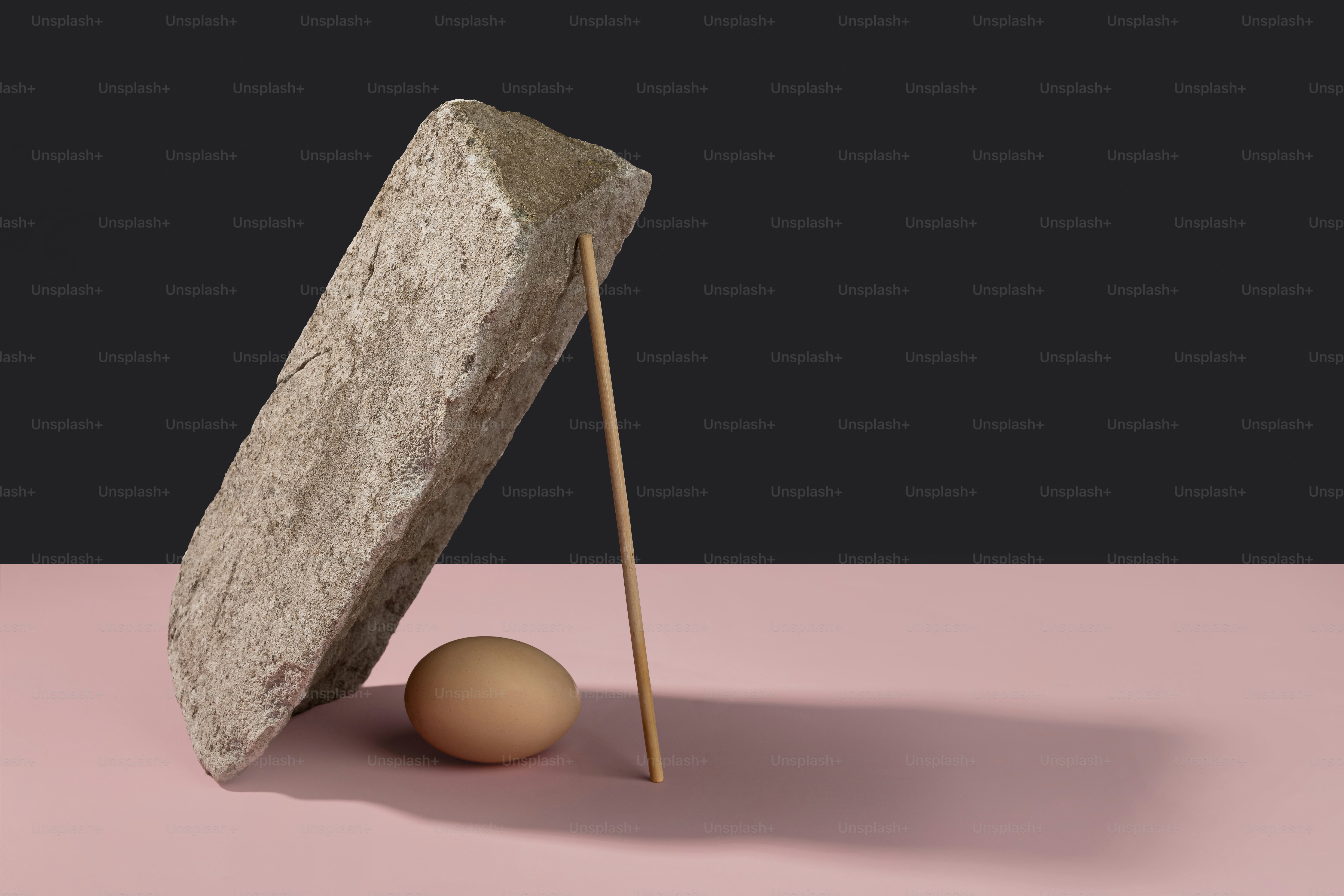 Stone, egg, and stick balanced precariously