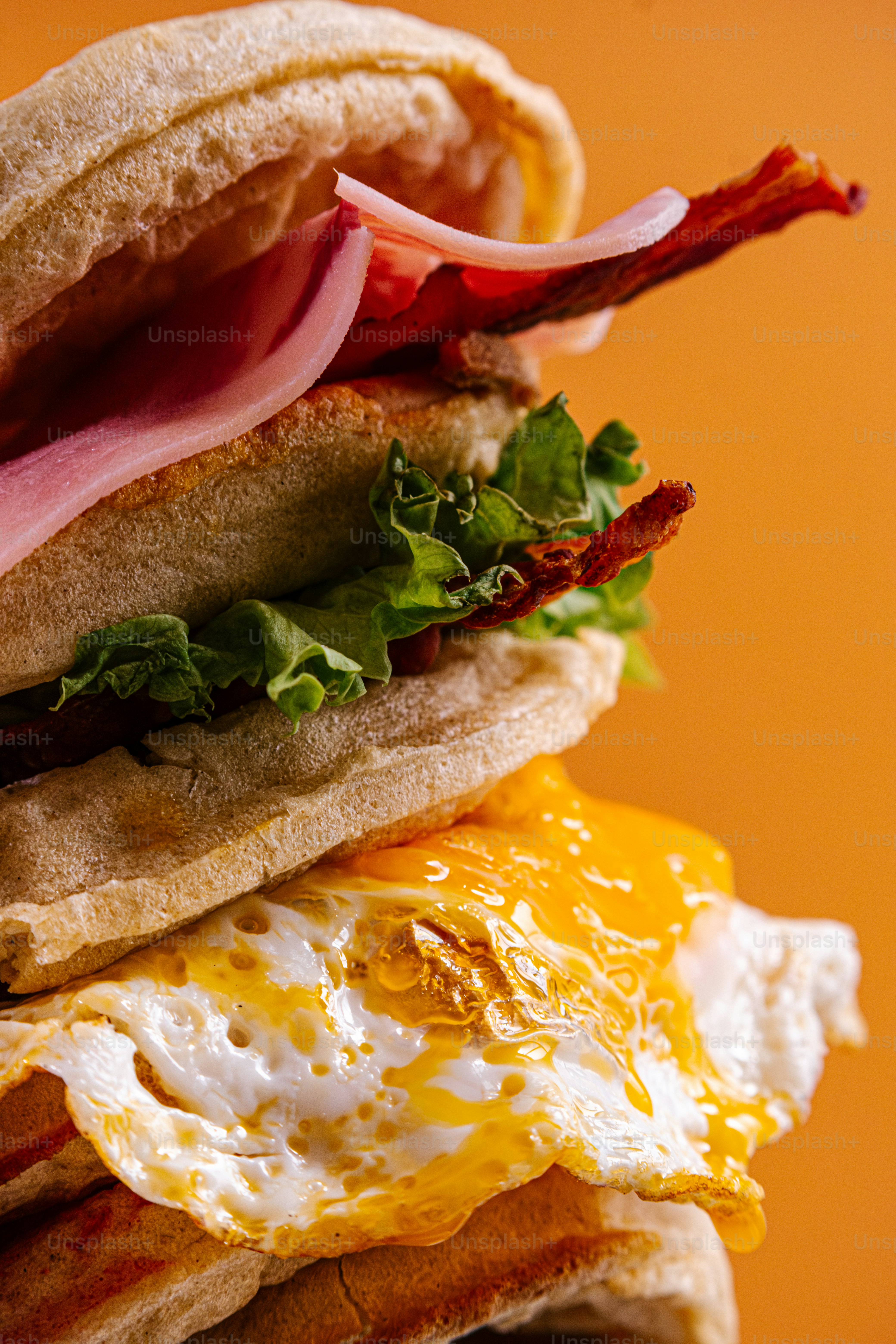 Um sanduíche de café da manhã com ovo, bacon e alface