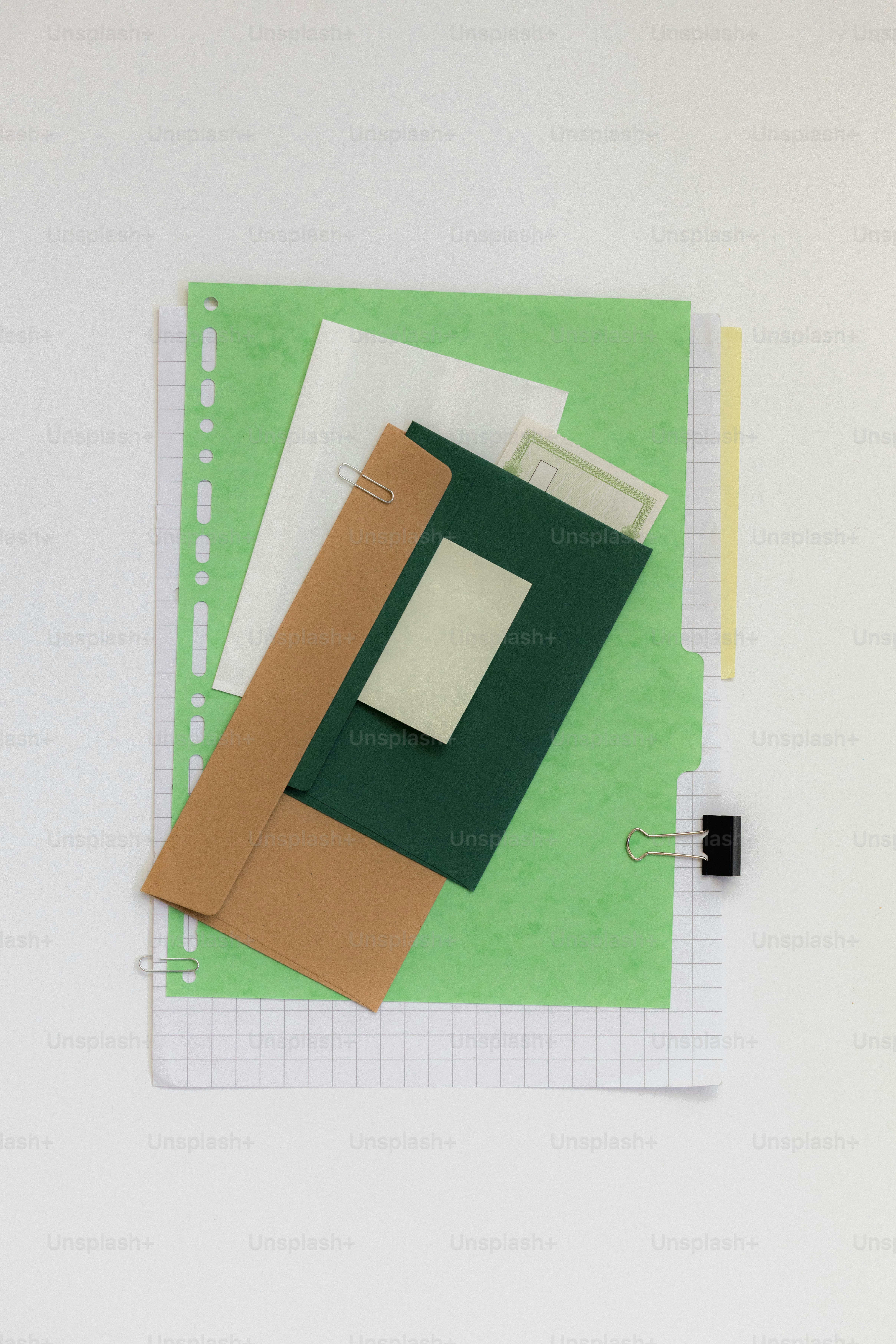 Various papers and clips on a grid notebook.