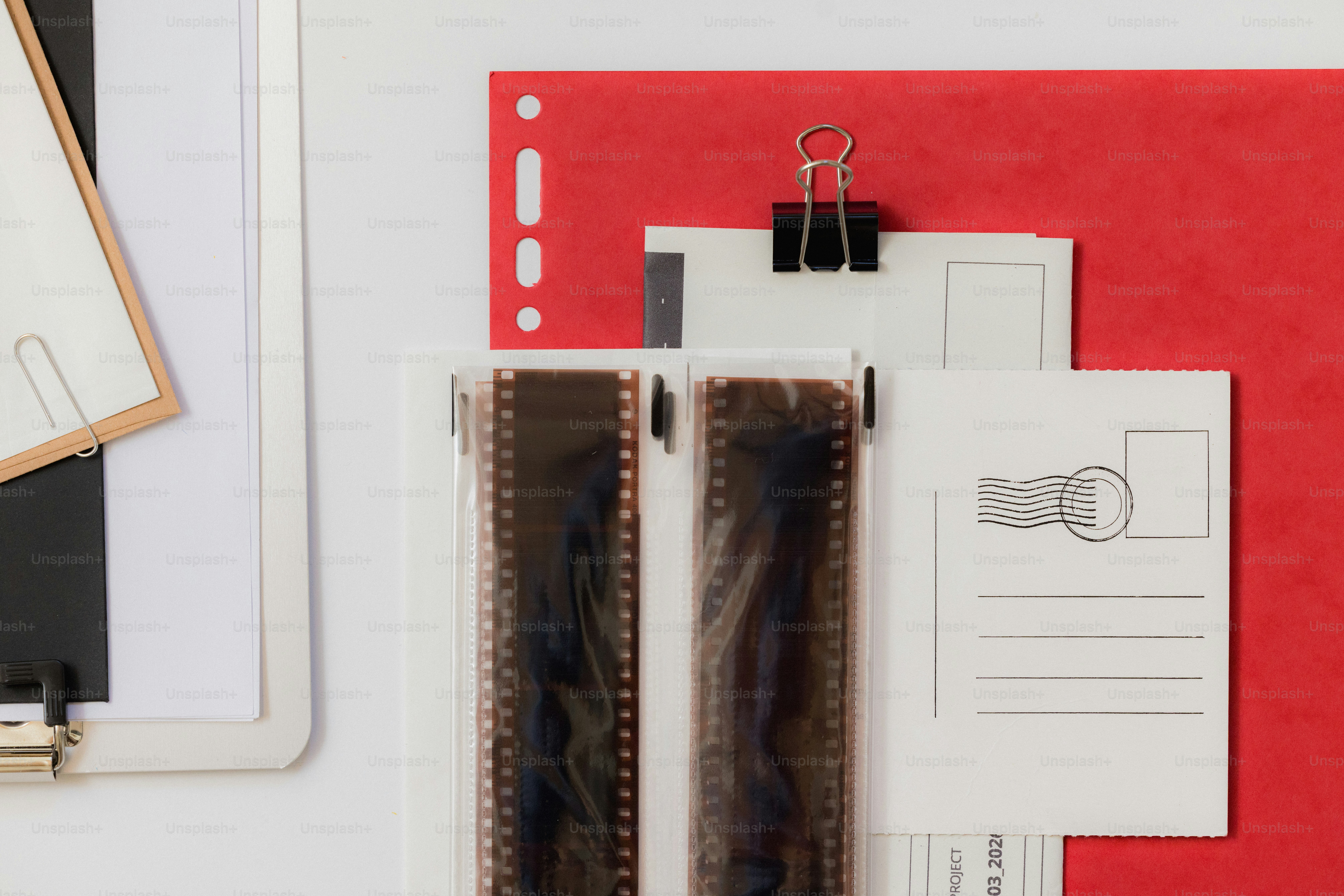 Two strips of film laid out on a desk.
