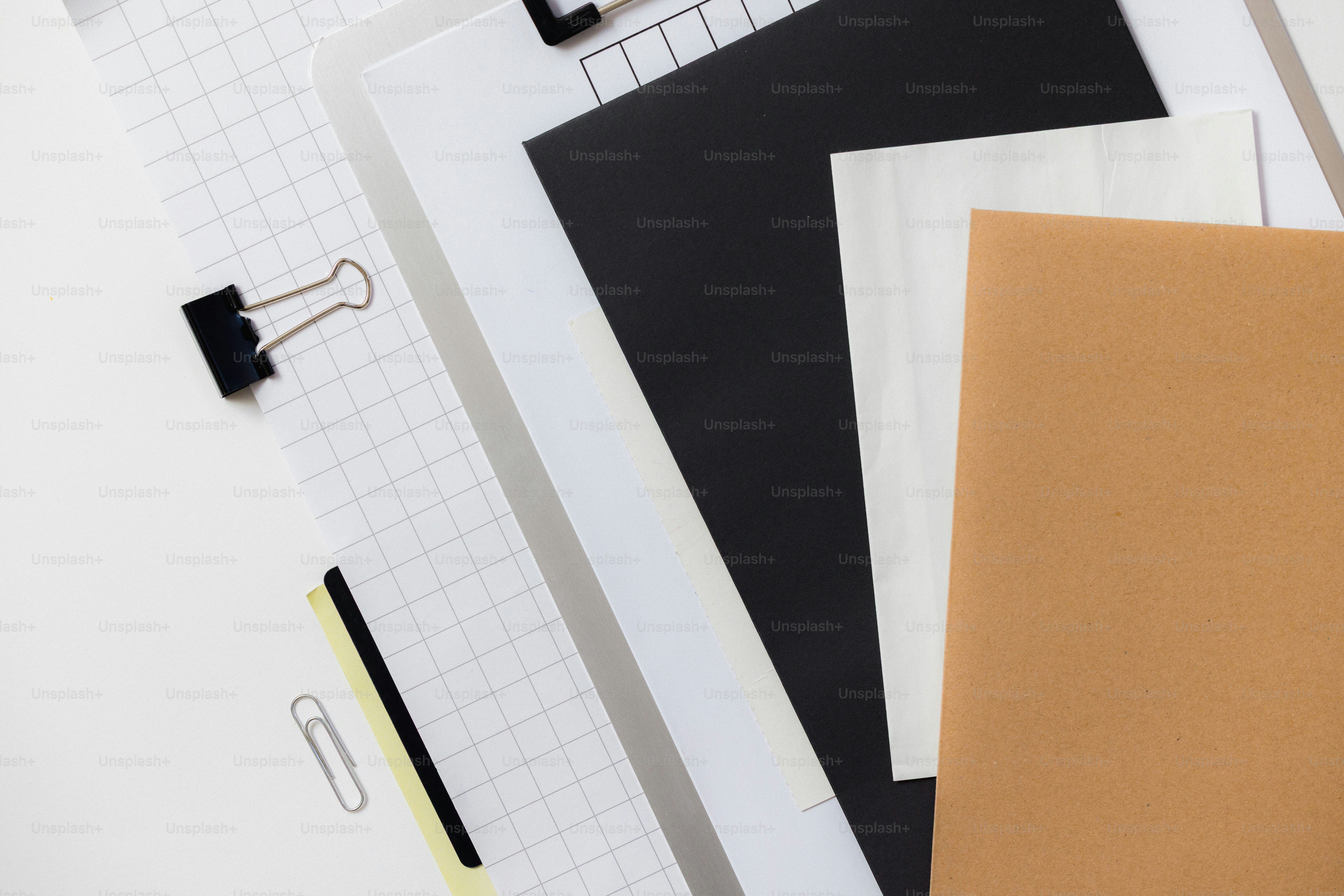 A blue folder with a paperclip and grid paper. photo – Business Image ...
