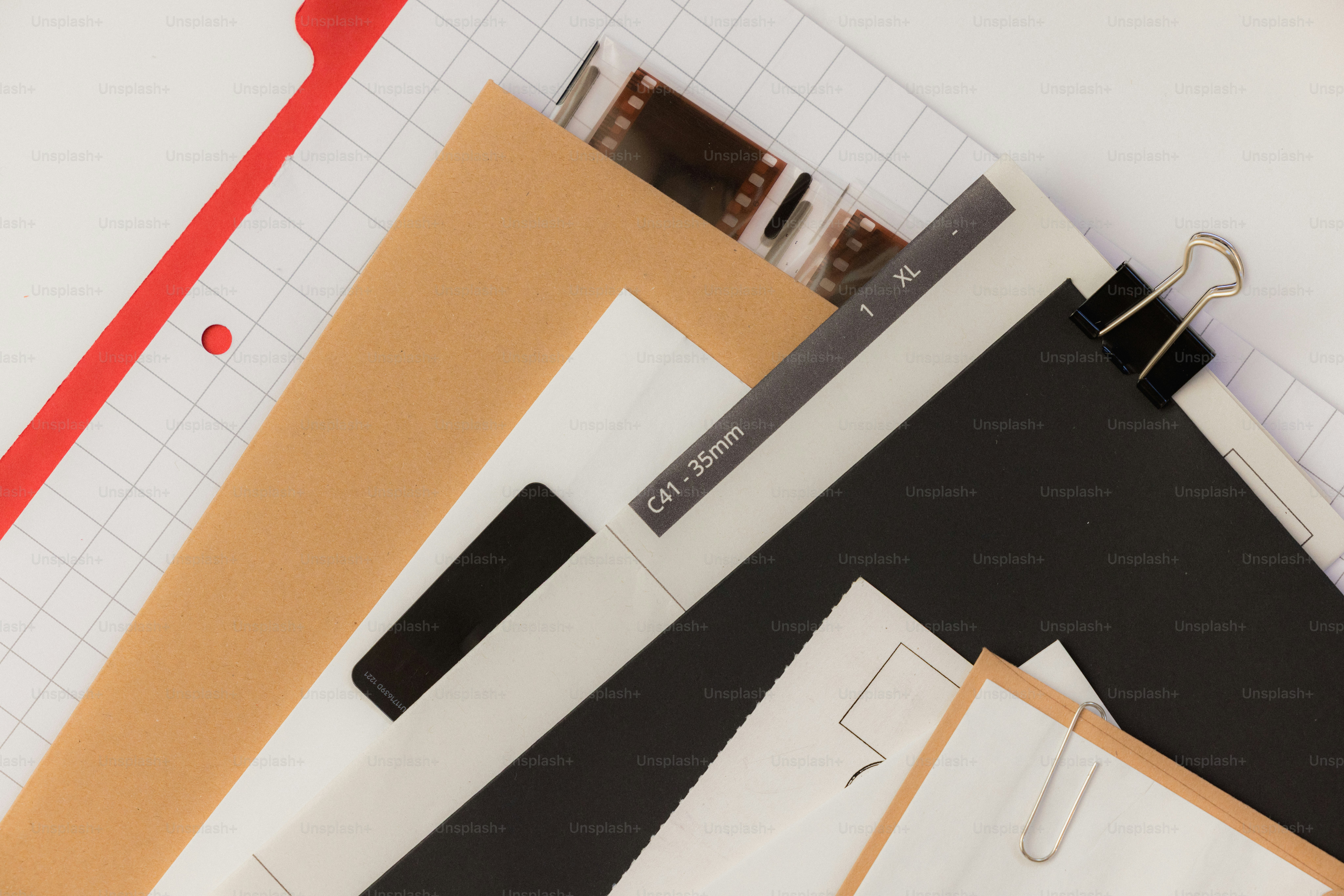 Various papers and film strips stacked together. photo – Photography ...
