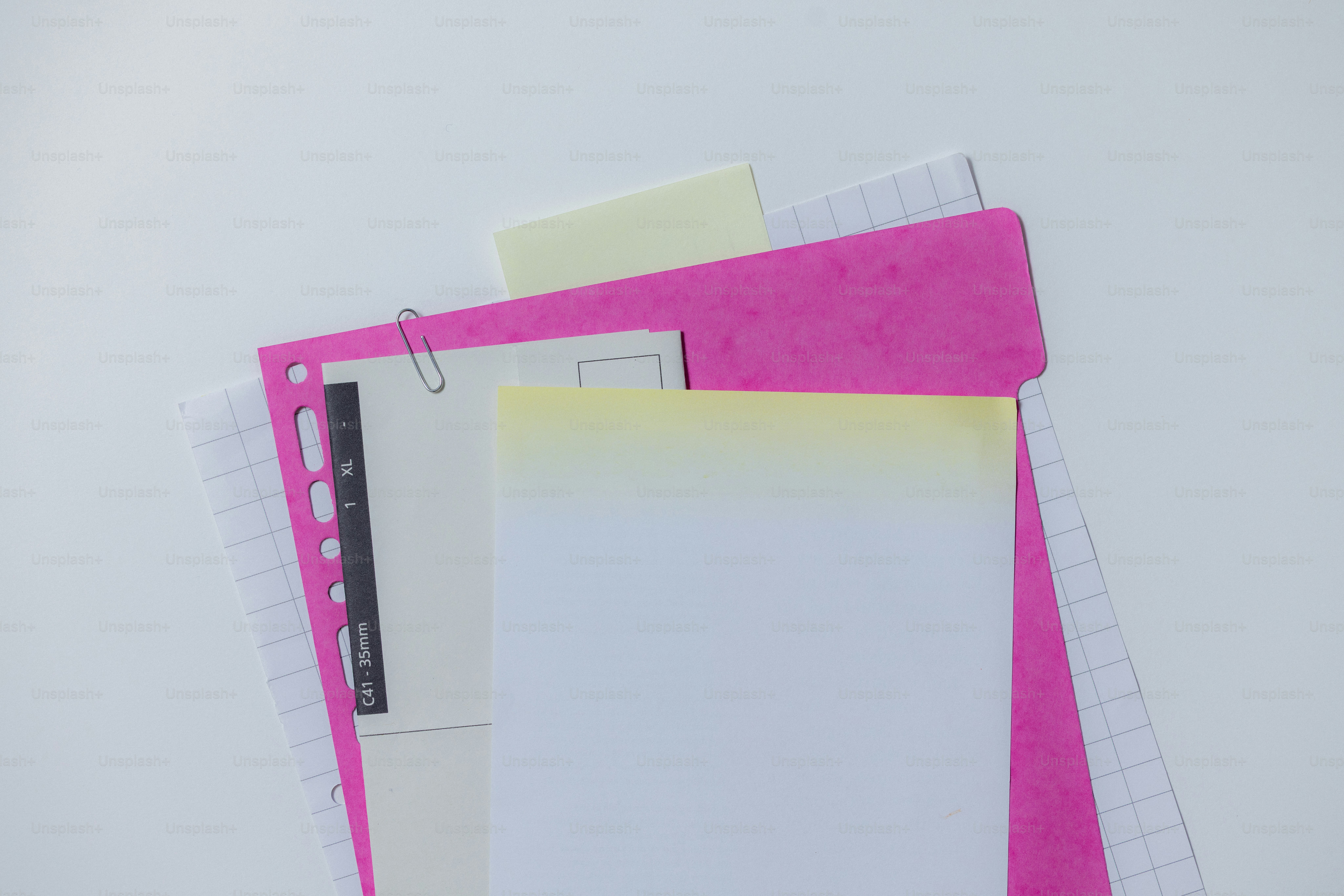 A blue folder with a paperclip and grid paper. photo – Business Image ...