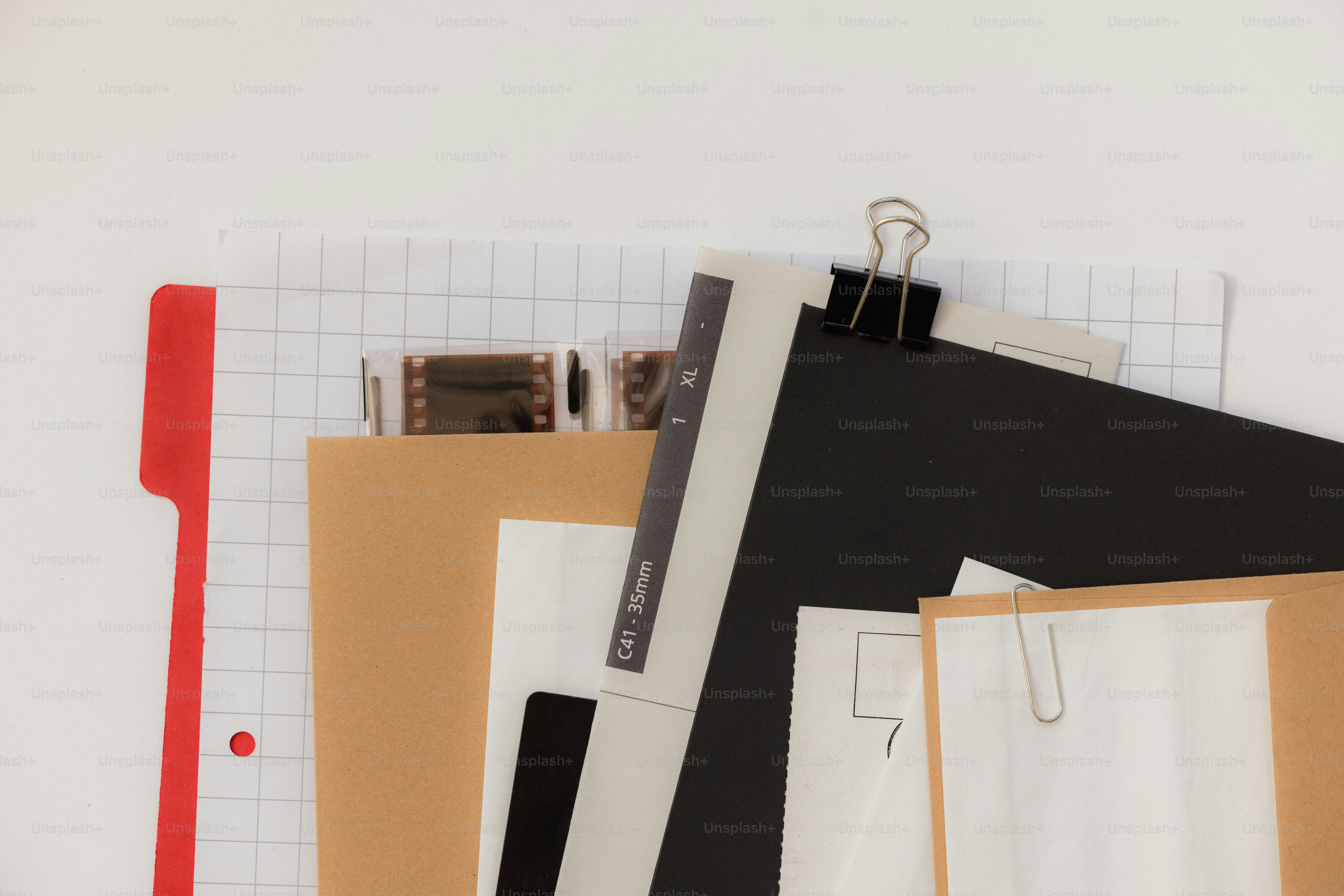 A collection of papers and film strips on a desk photo – Photography ...