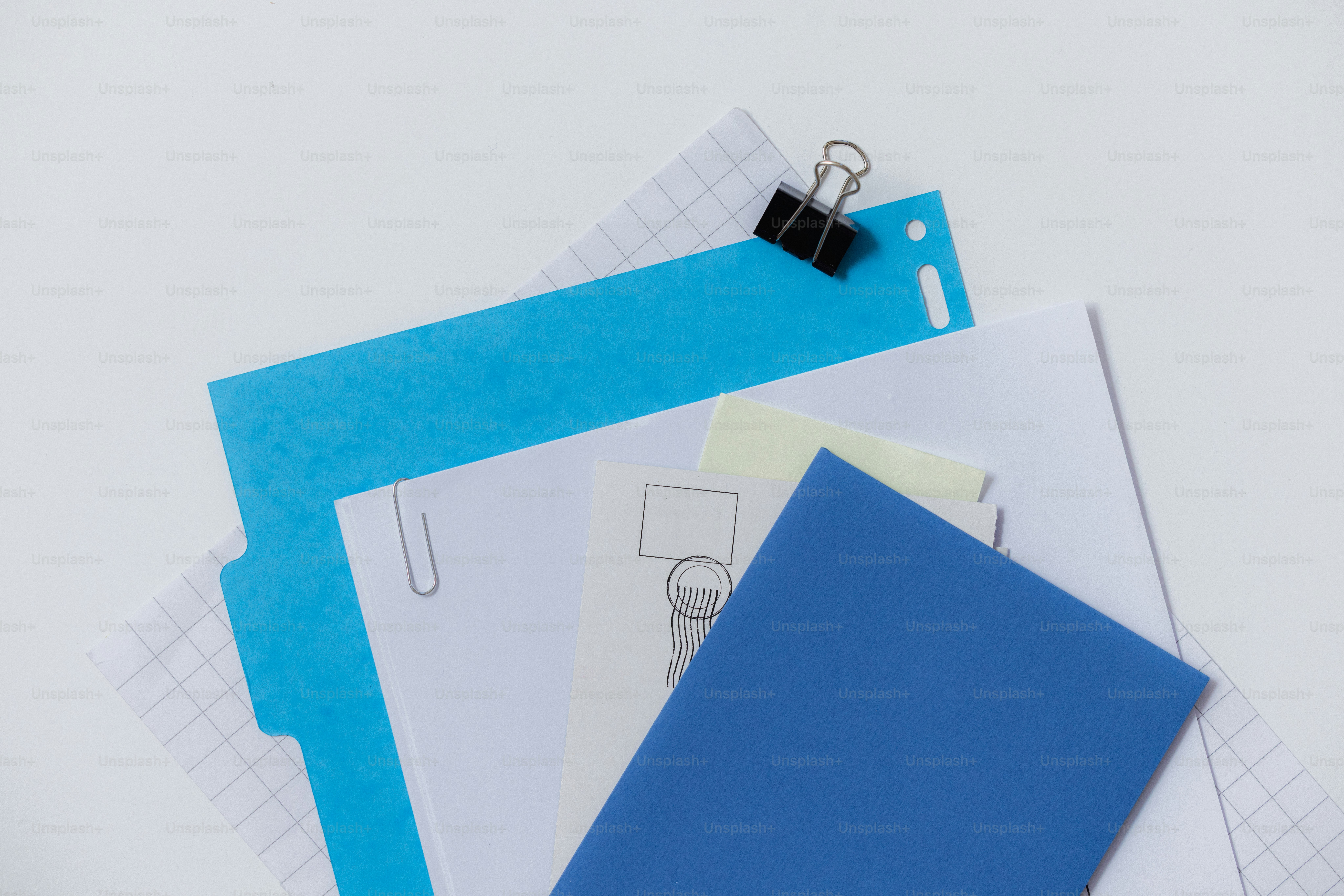 Stack of papers and red folder with binder clip photo – Paper Image on ...