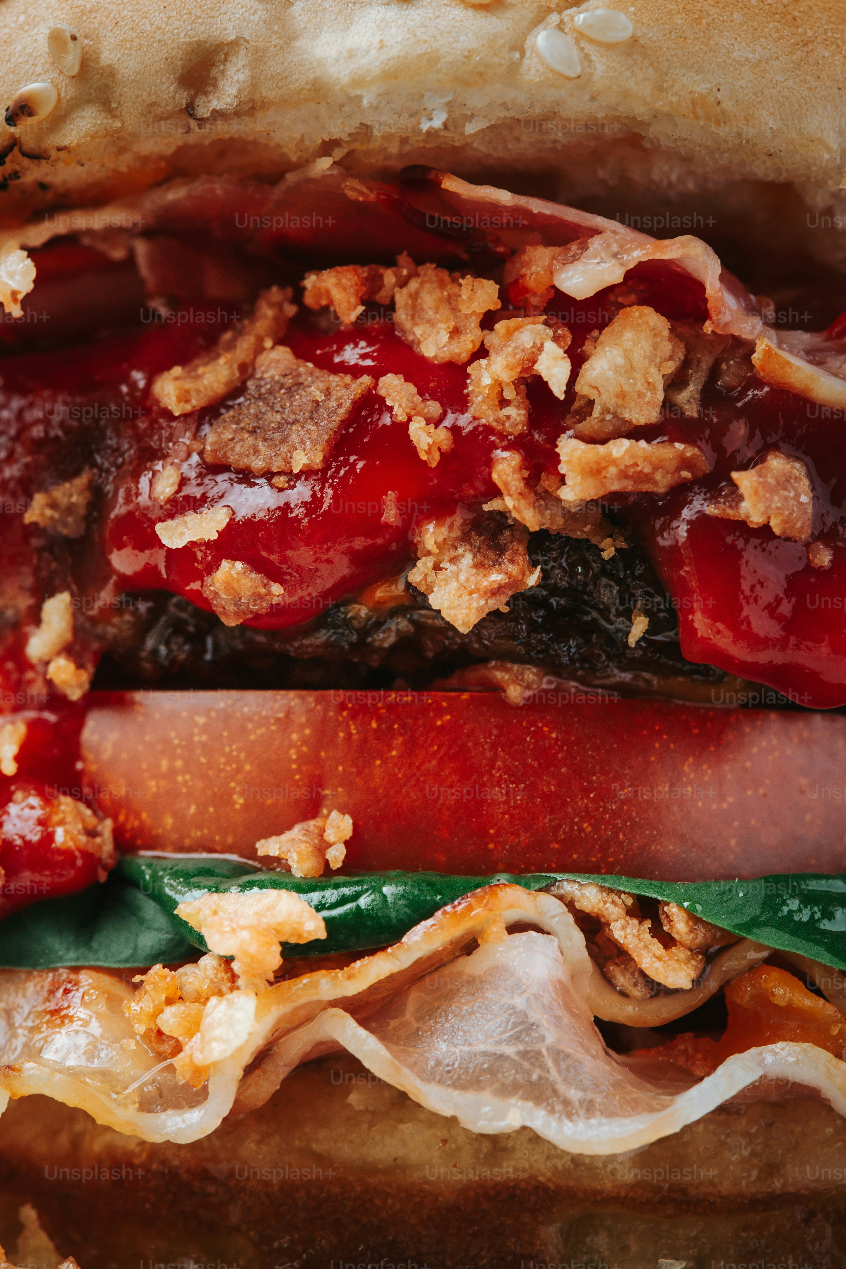 Close-up of a juicy bacon cheeseburger with toppings.