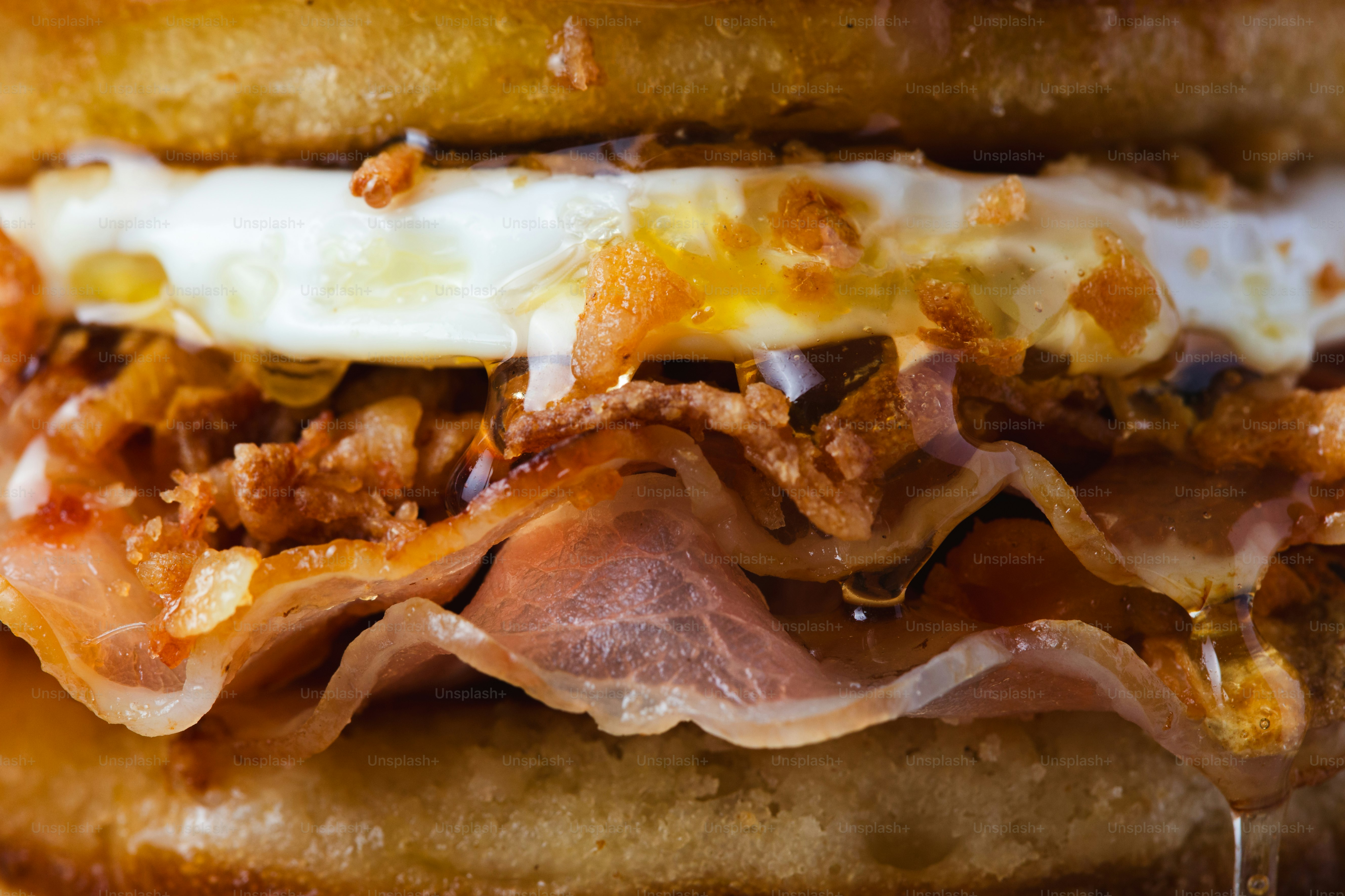 Close-up of a delicious breakfast sandwich with bacon and egg.