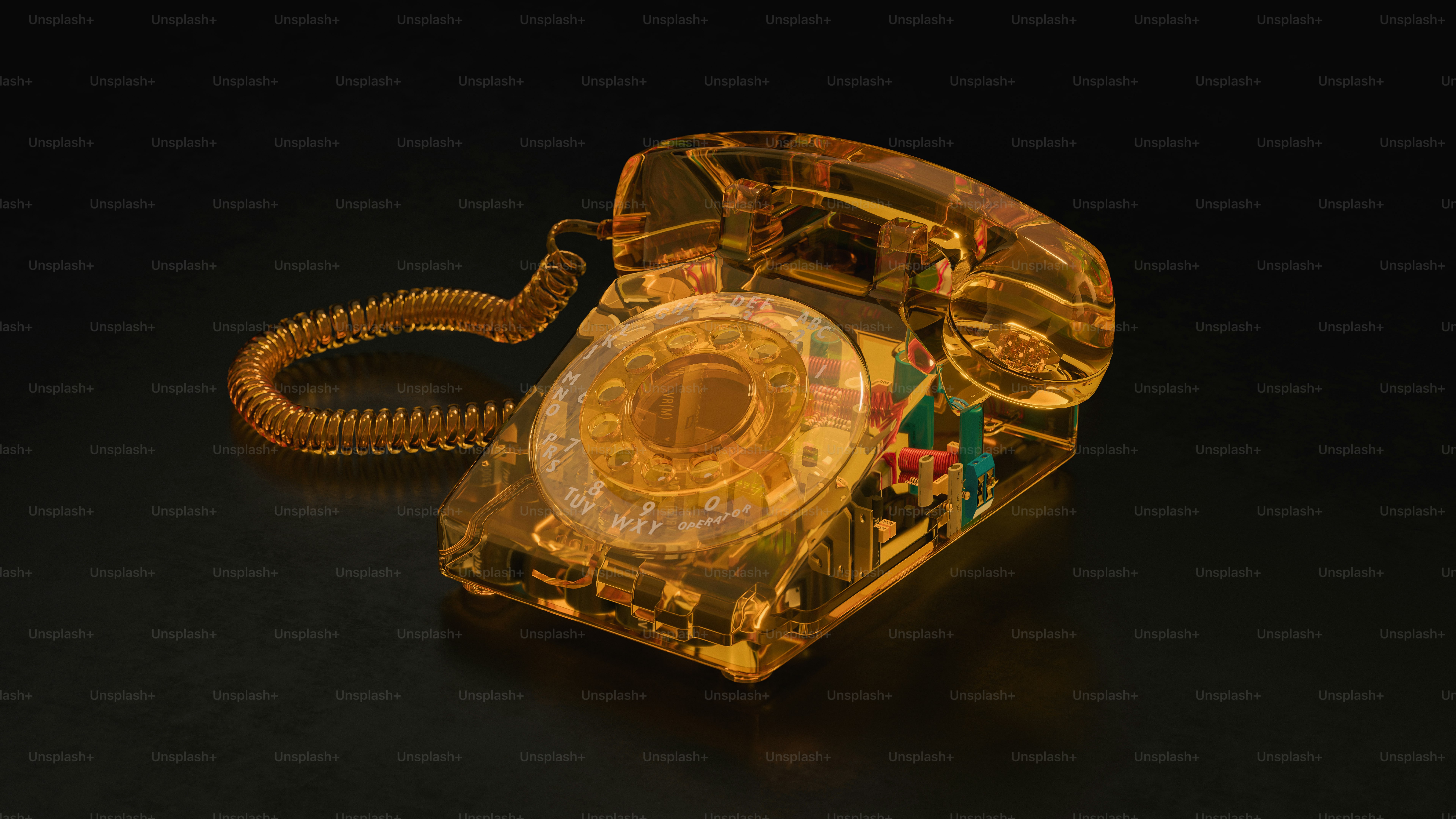 A transparent amber rotary telephone on a dark surface.