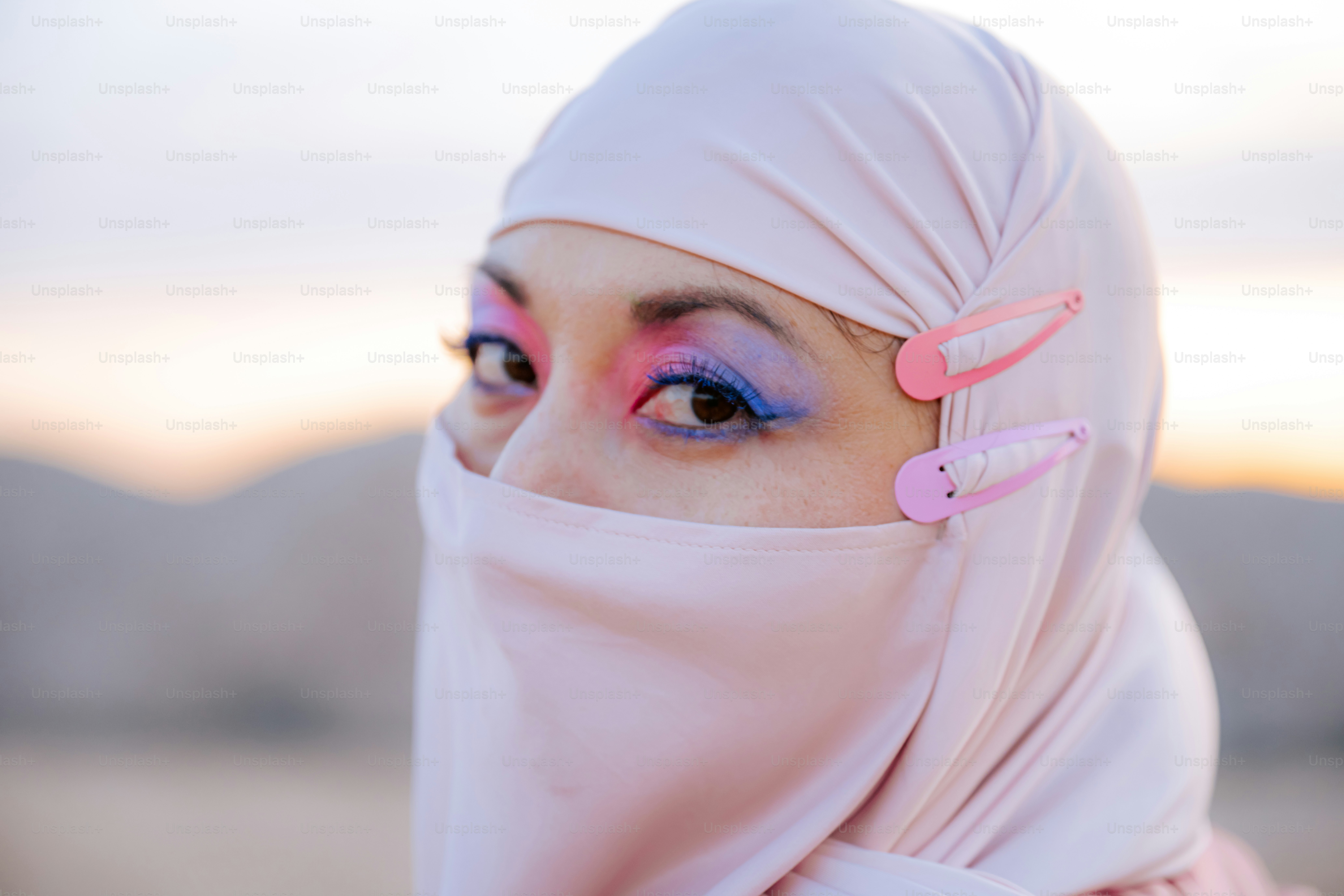 Woman with colorful eye makeup and pink hijab