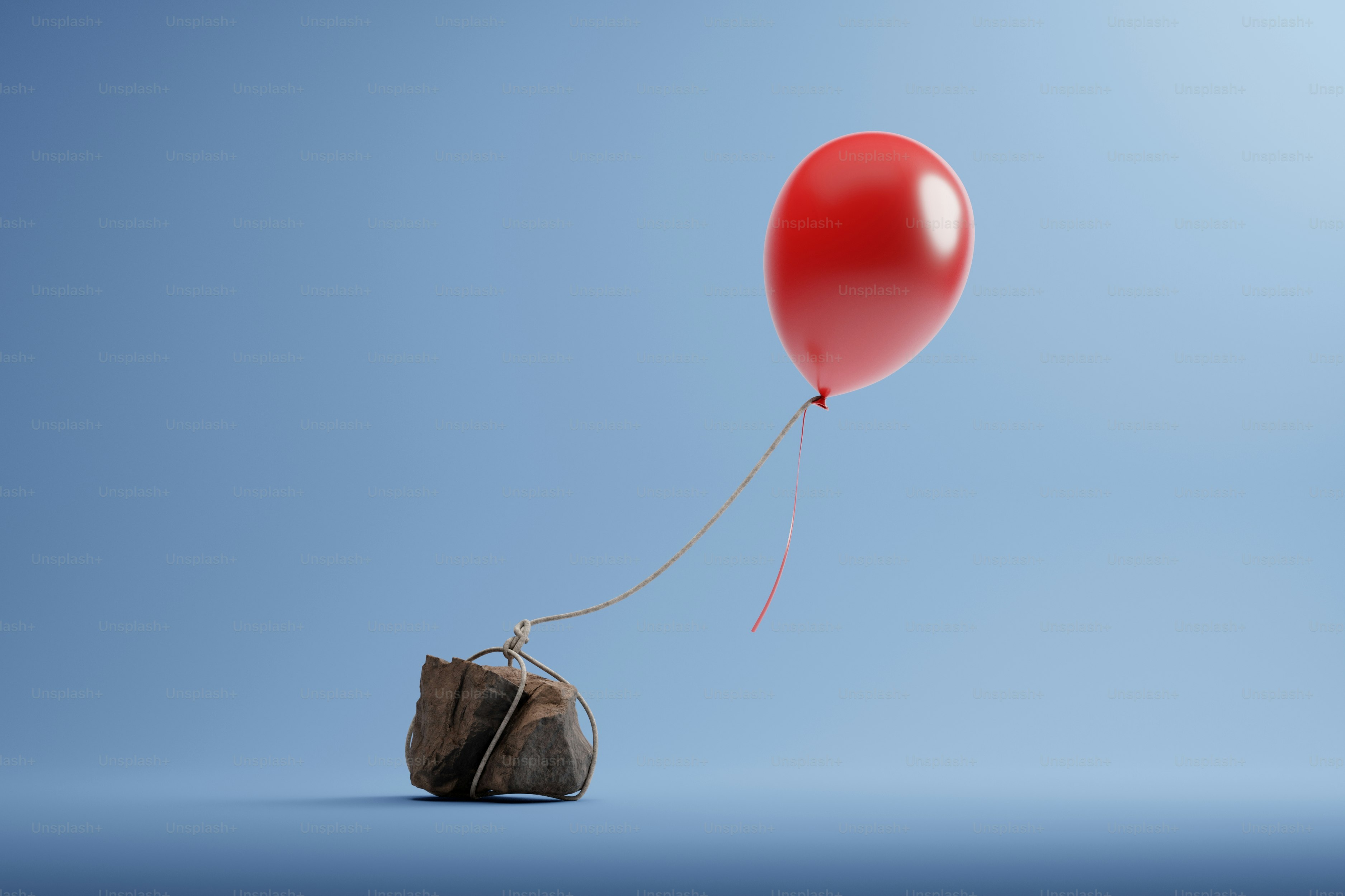 Balon merah mengangkat tas coklat kecil.