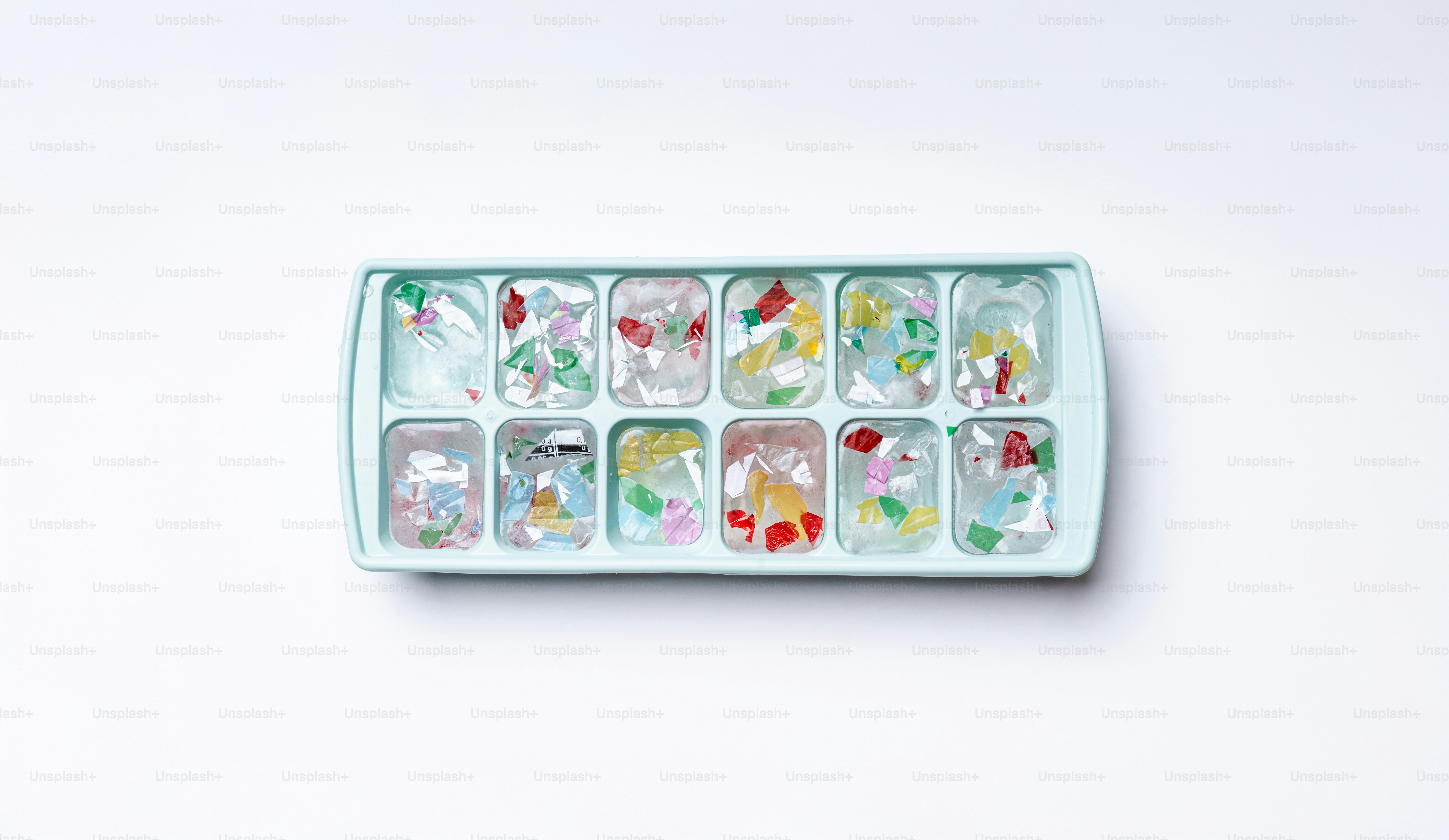 Ice cube tray with colorful floral elements frozen inside cubes