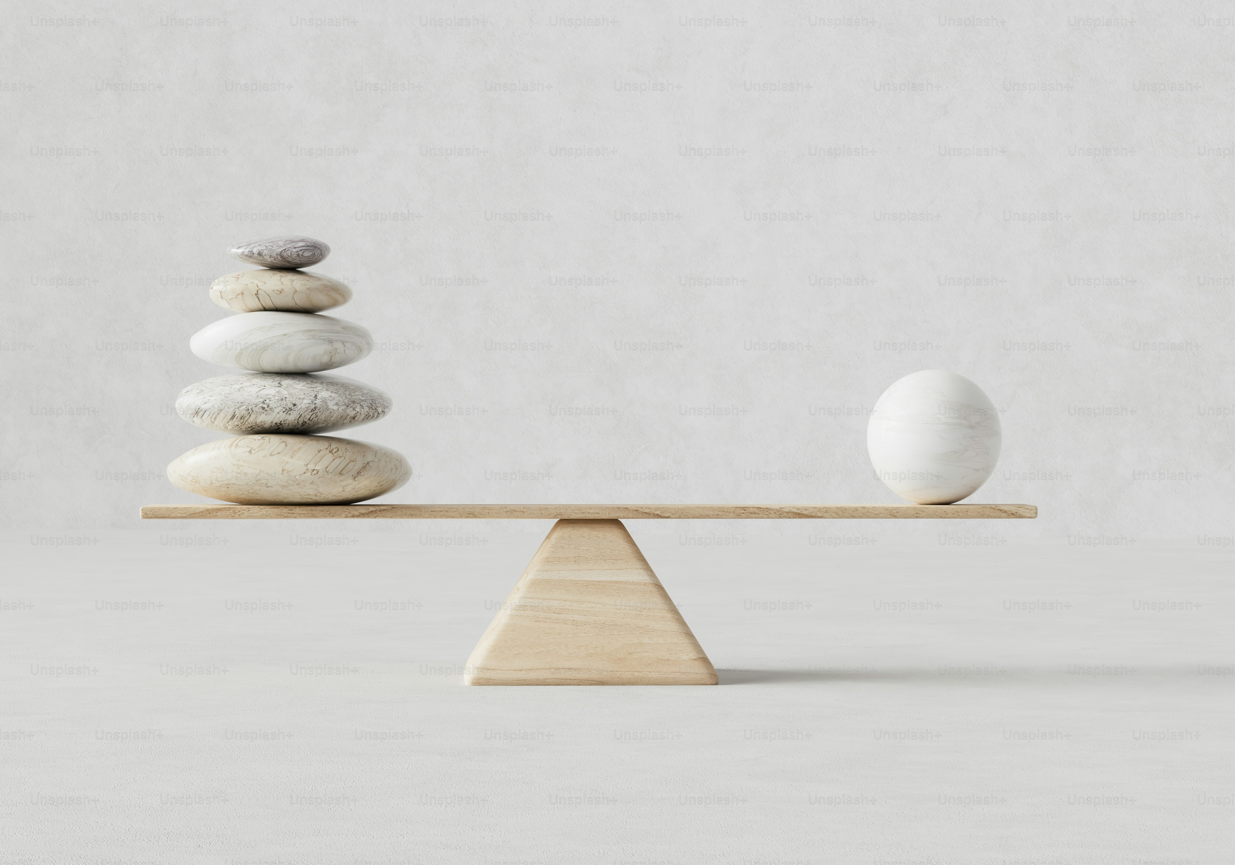 Stacked stones and an egg on a wooden balance scale
