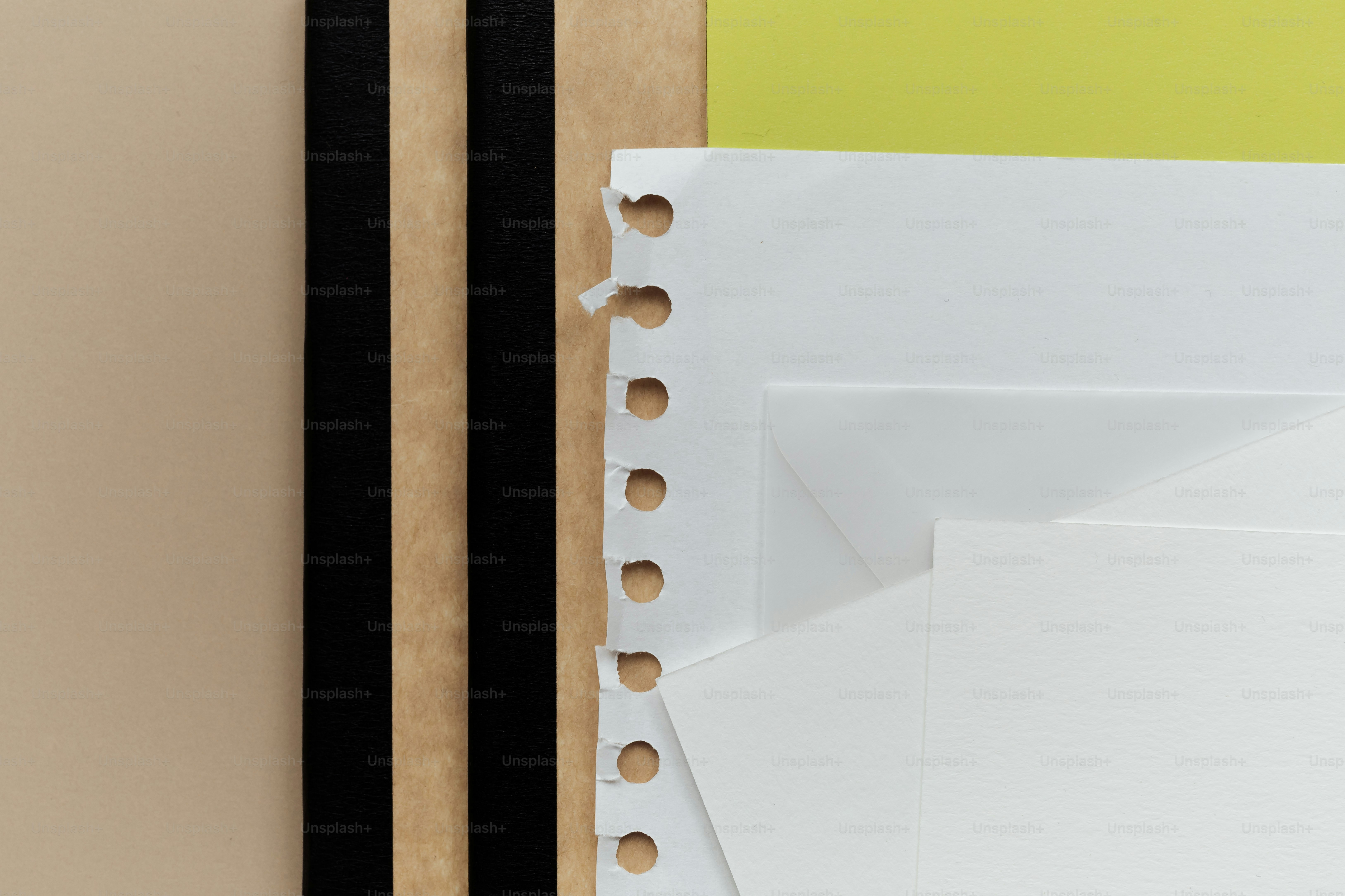 Brown, black, and yellow papers with white sheets.