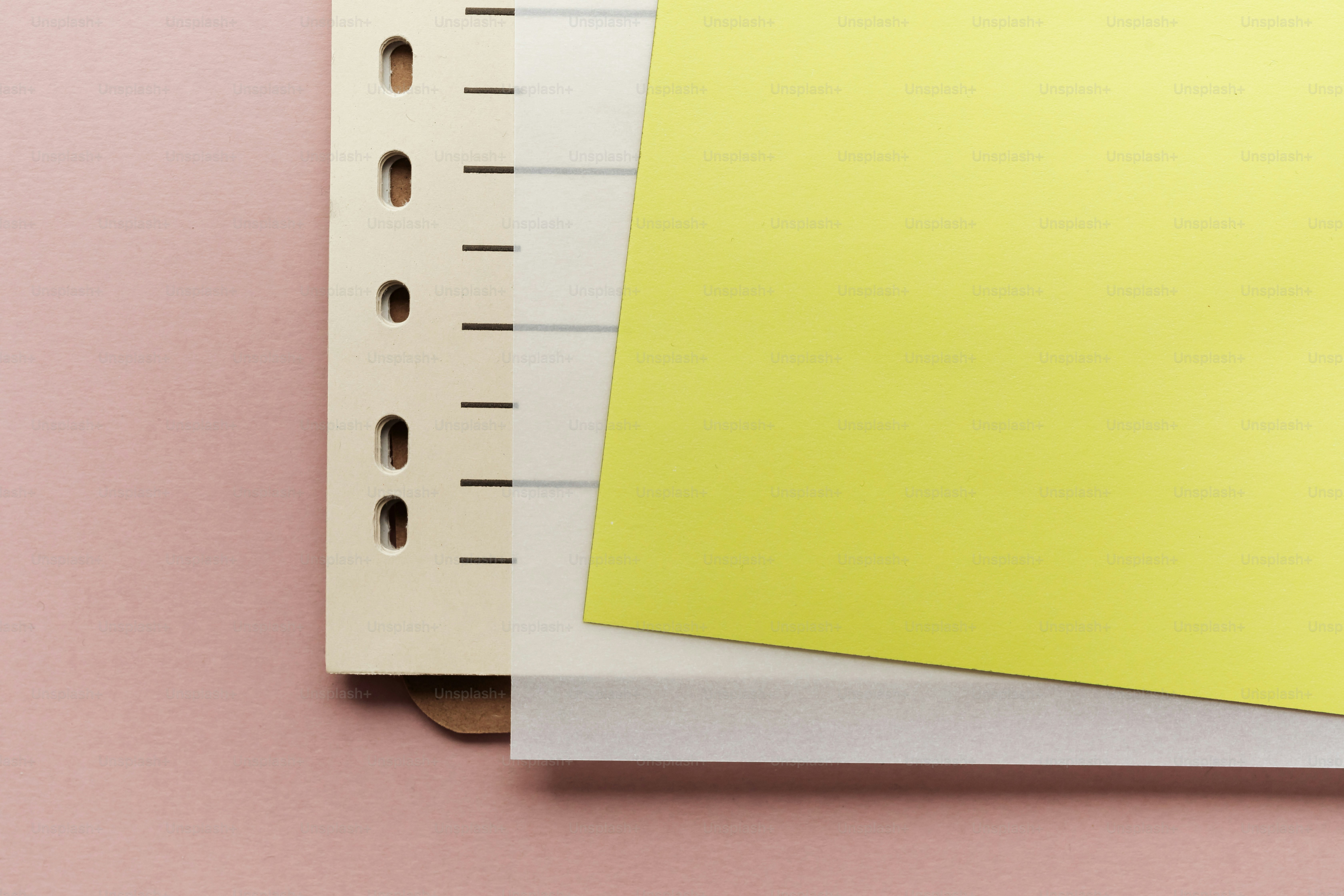 Yellow paper on a binder with pink background