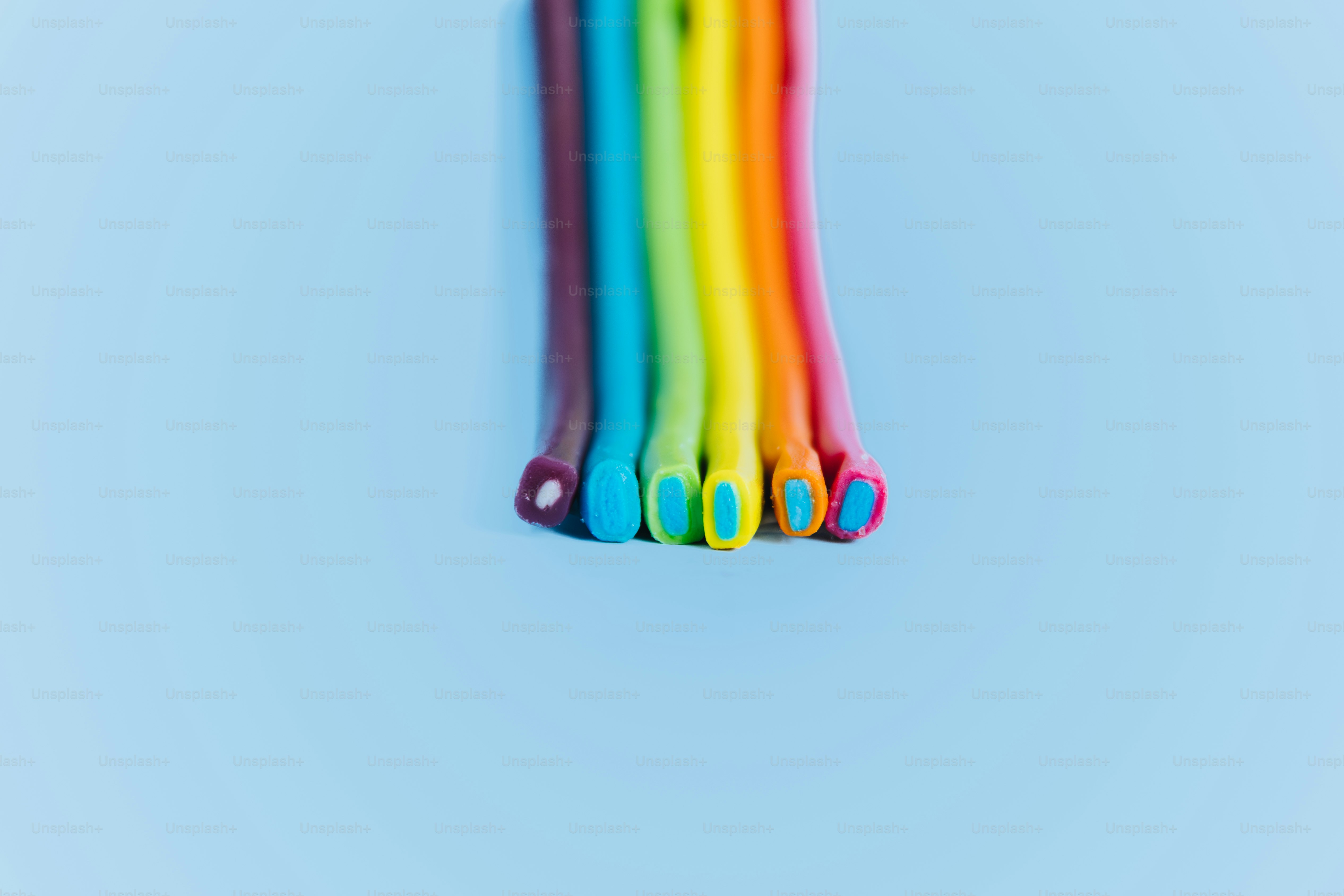 Colorful gummy worms arranged in a rainbow pattern