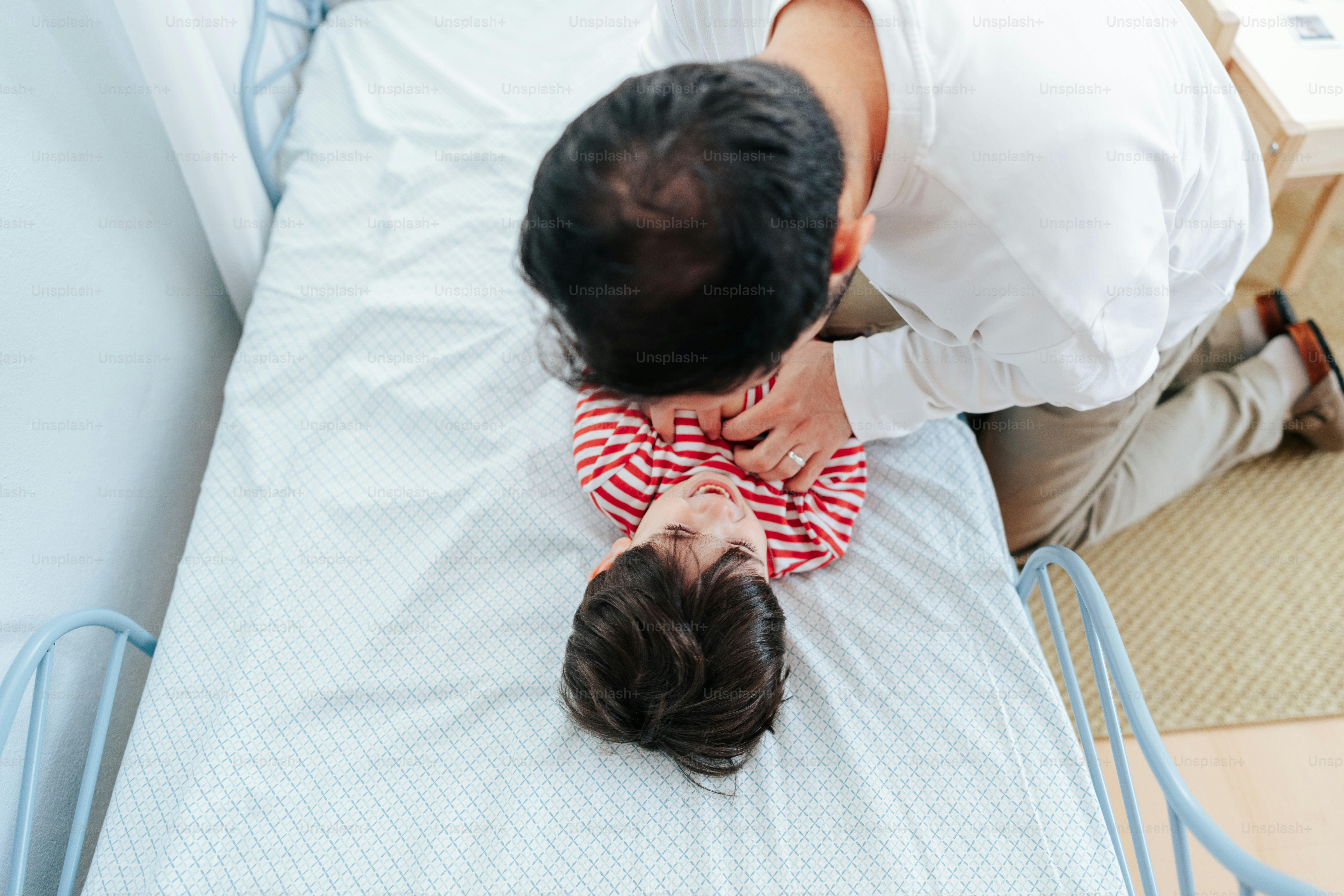 Ayah dan anak berbaring di tempat tidur