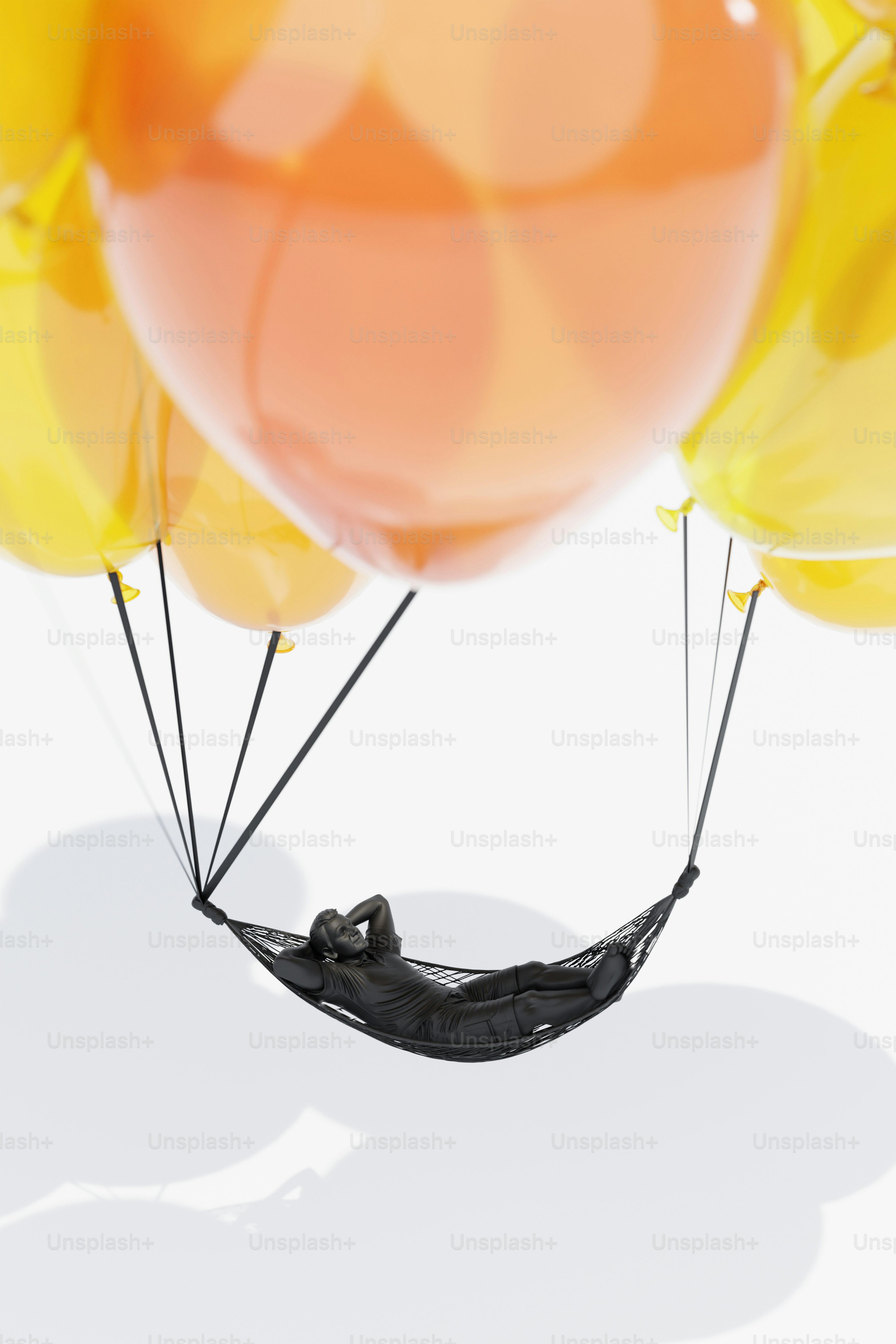 Person relaxing in hammock suspended by balloons