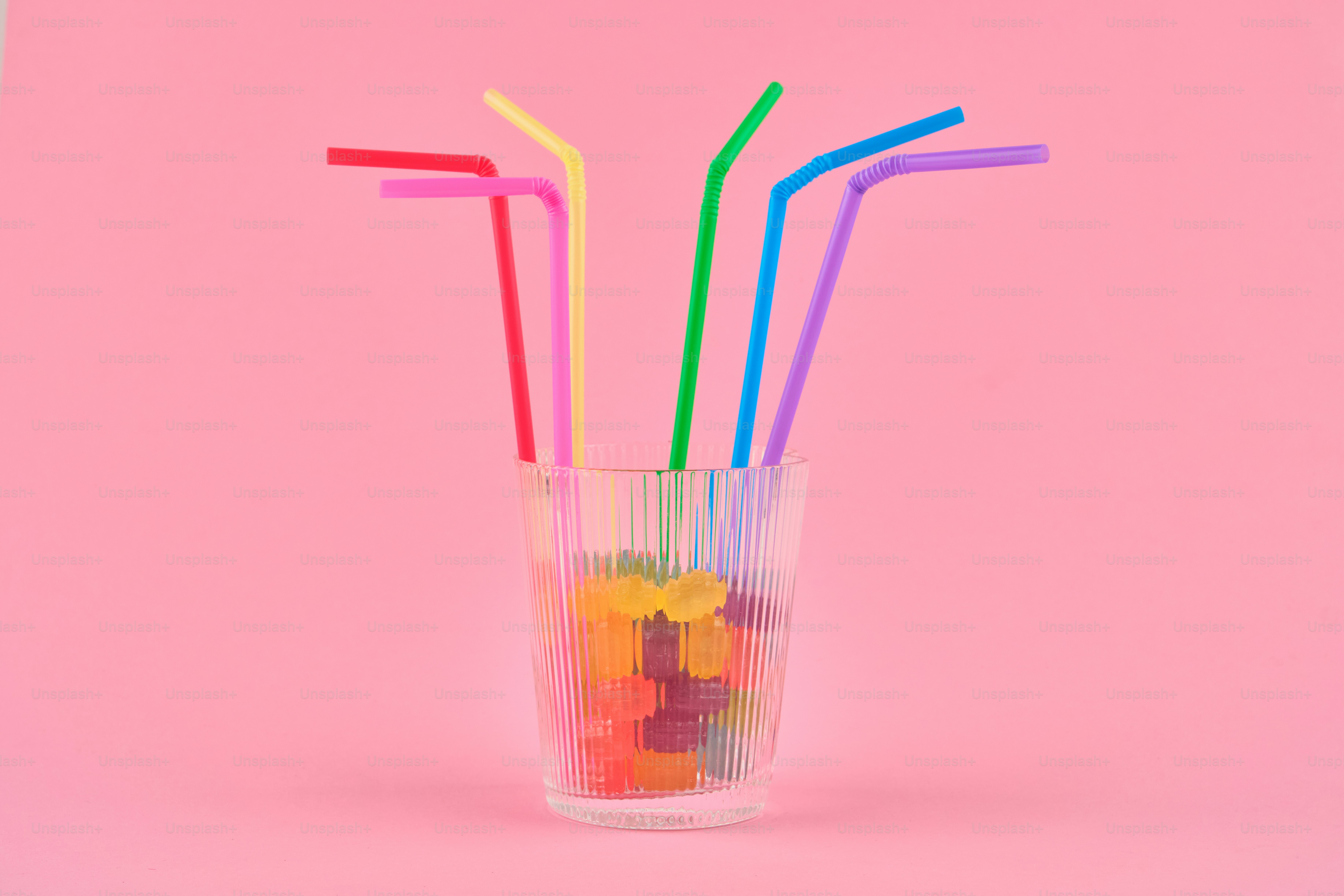 Colorful straws and gummy bears in a glass