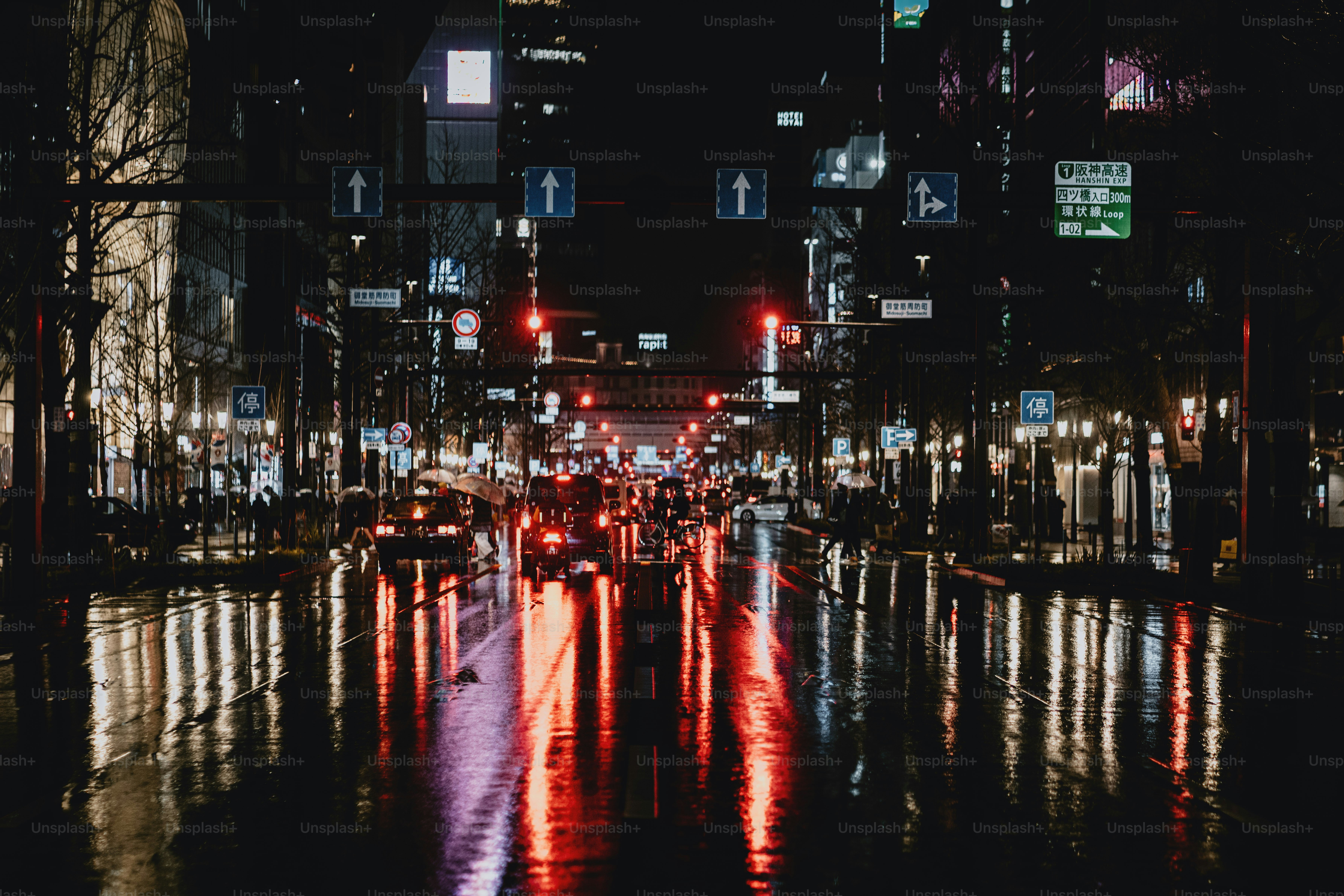 Calle lluviosa de la ciudad por la noche con reflejos