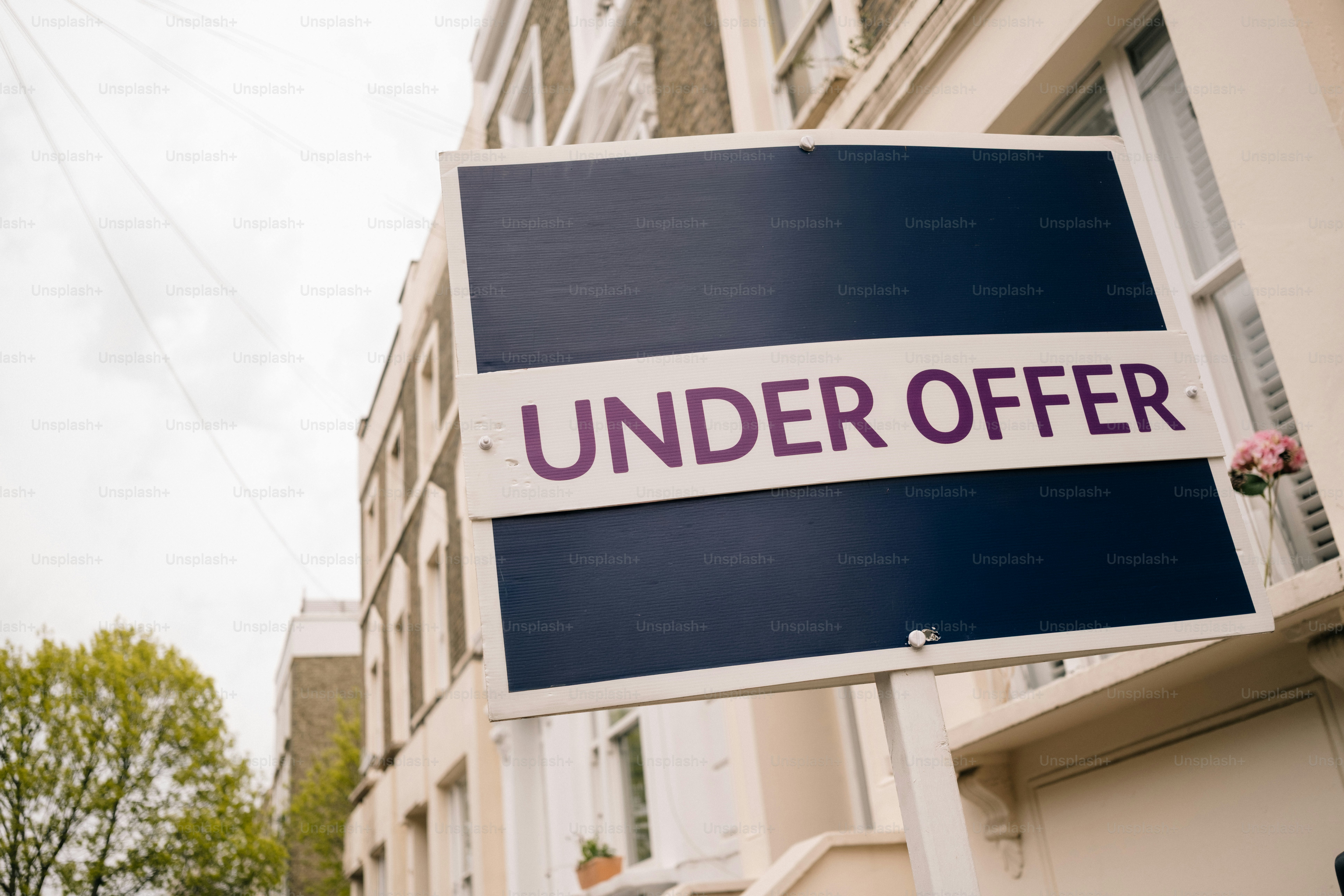 A blue for sale sign outside a brick house. photo – Real estate Image ...