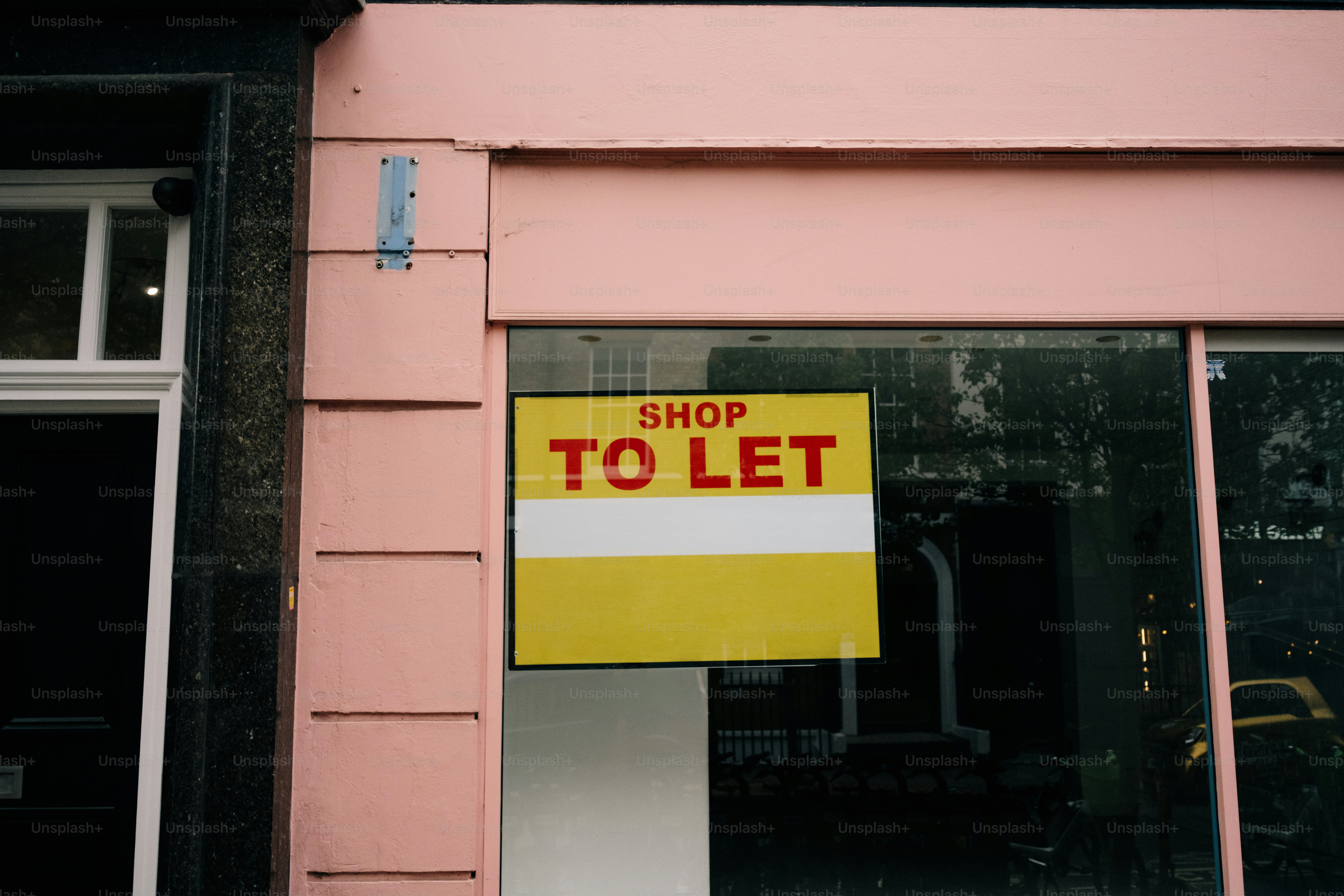 Shop to let sign on a pink storefront photo – Real estate Image on Unsplash