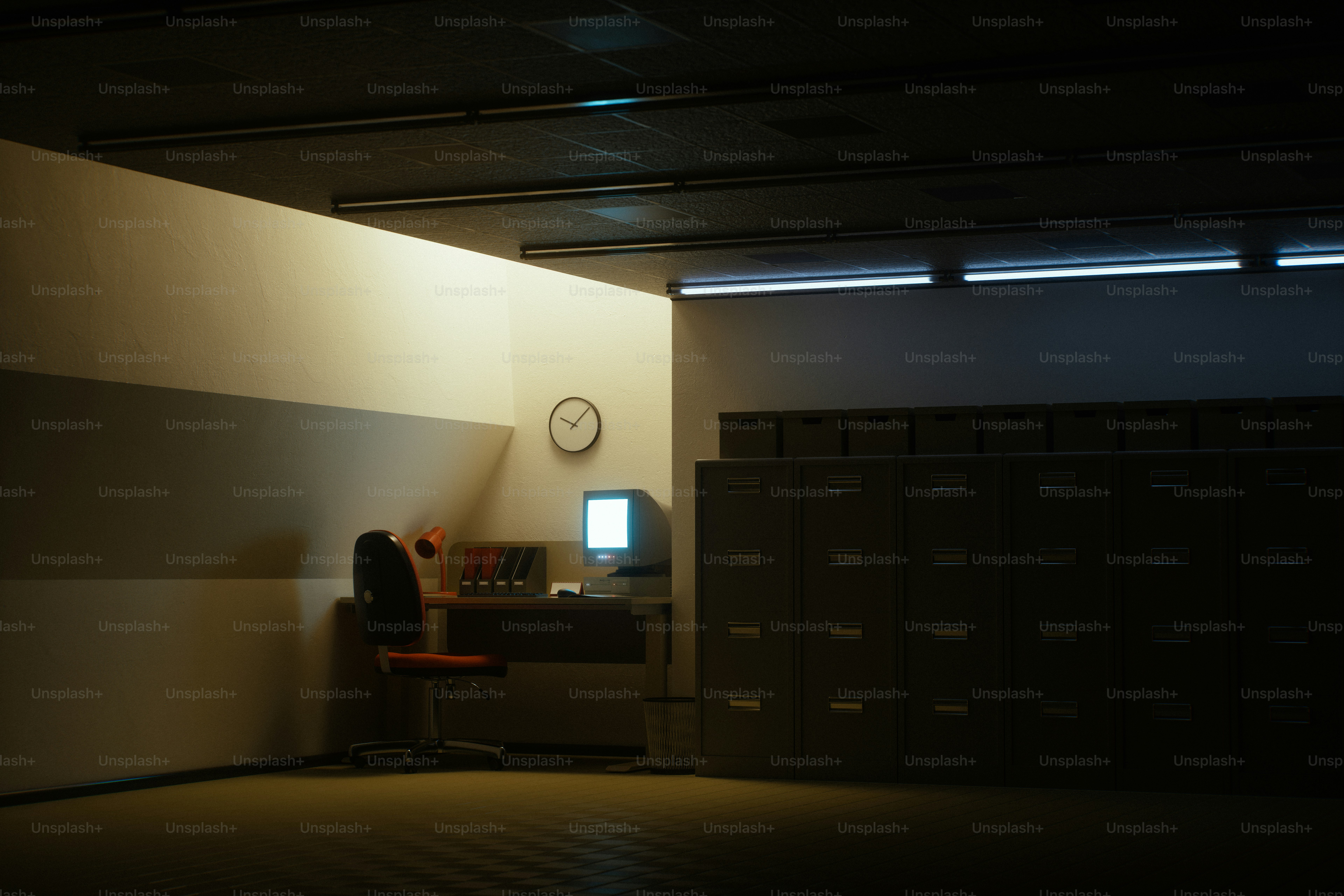 Dimly lit office with filing cabinets and a computer.