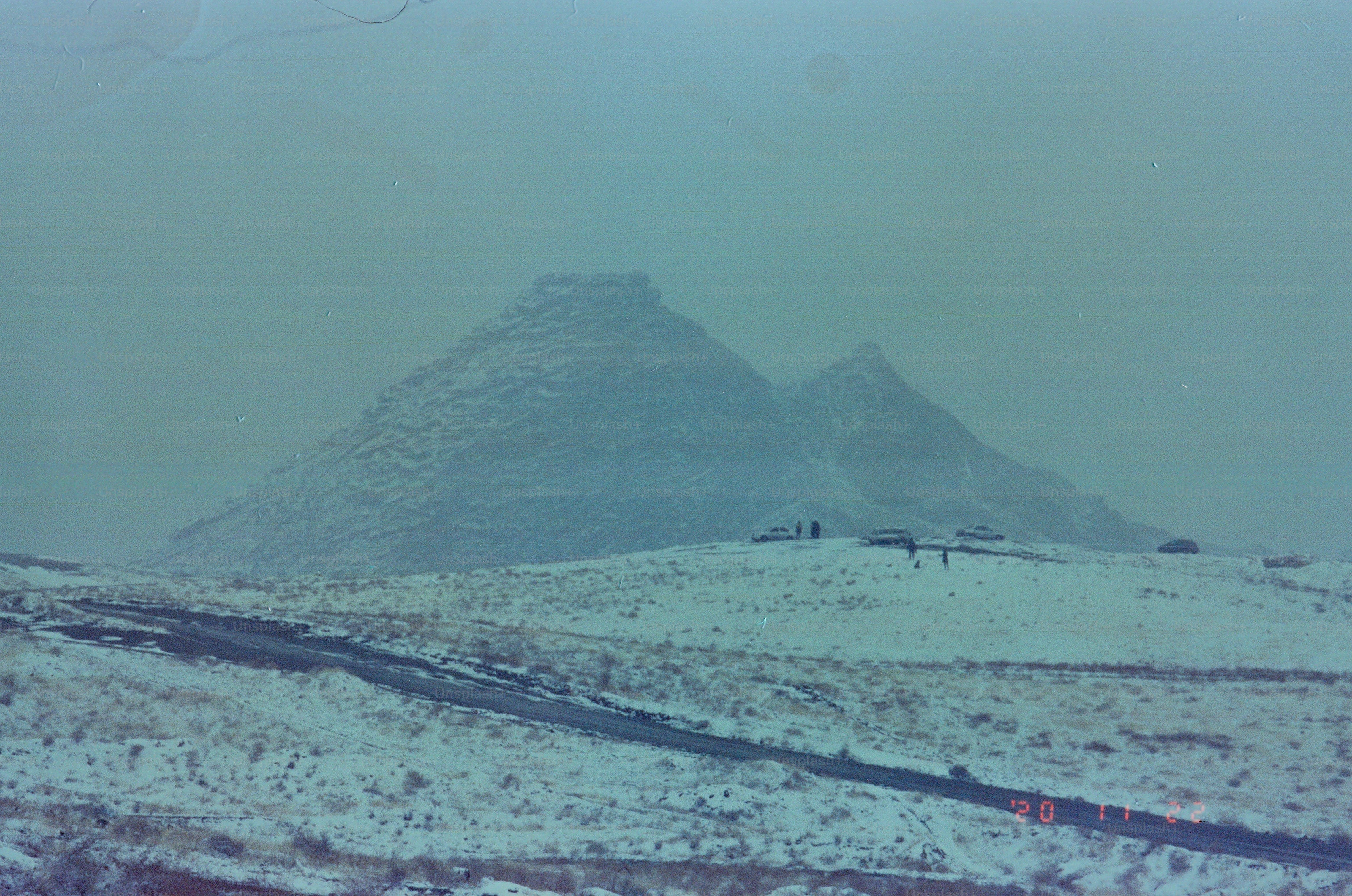 Snow covered mountains under a hazy sky