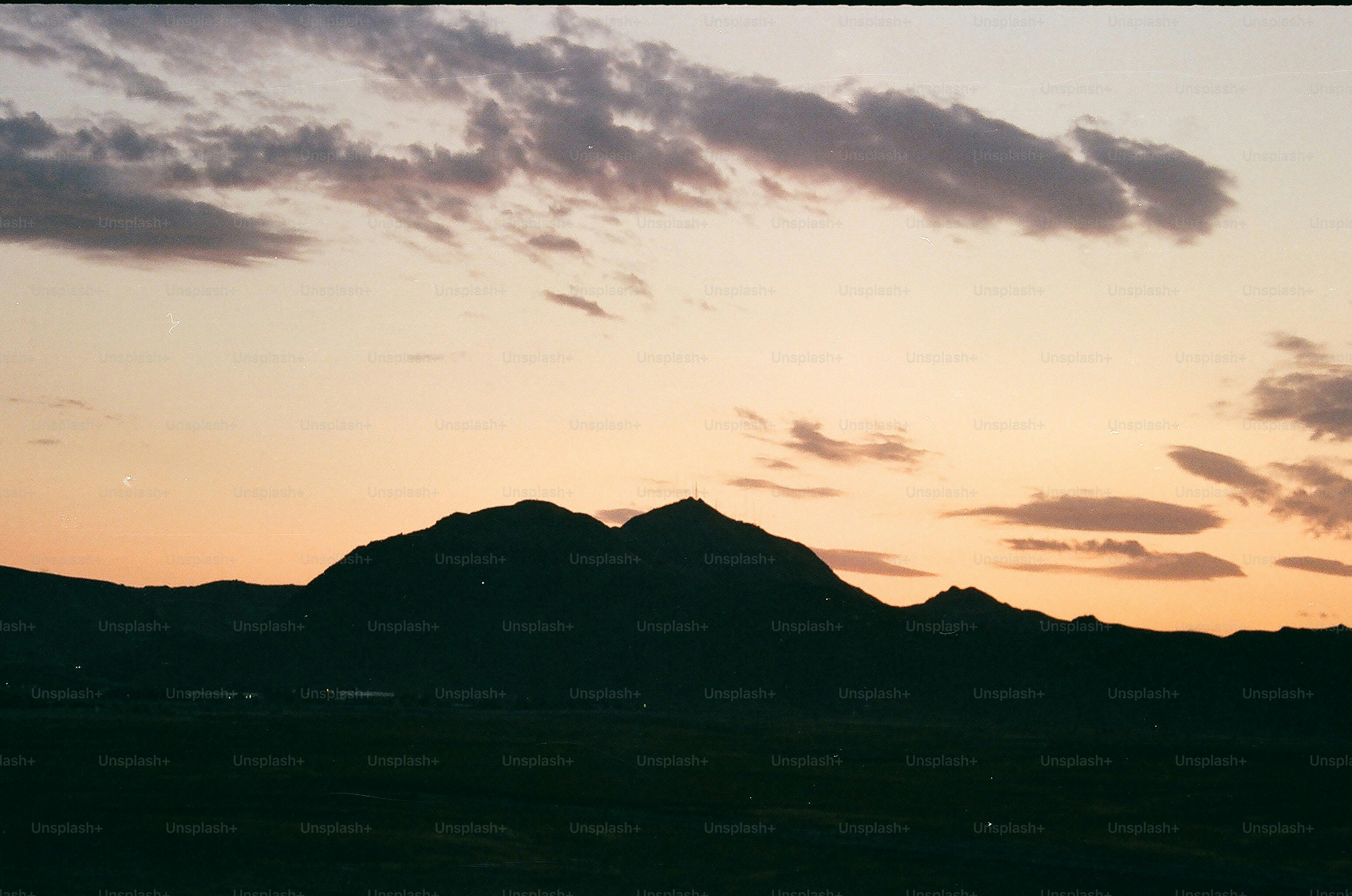 Silhouette of mountains against a dusky sky