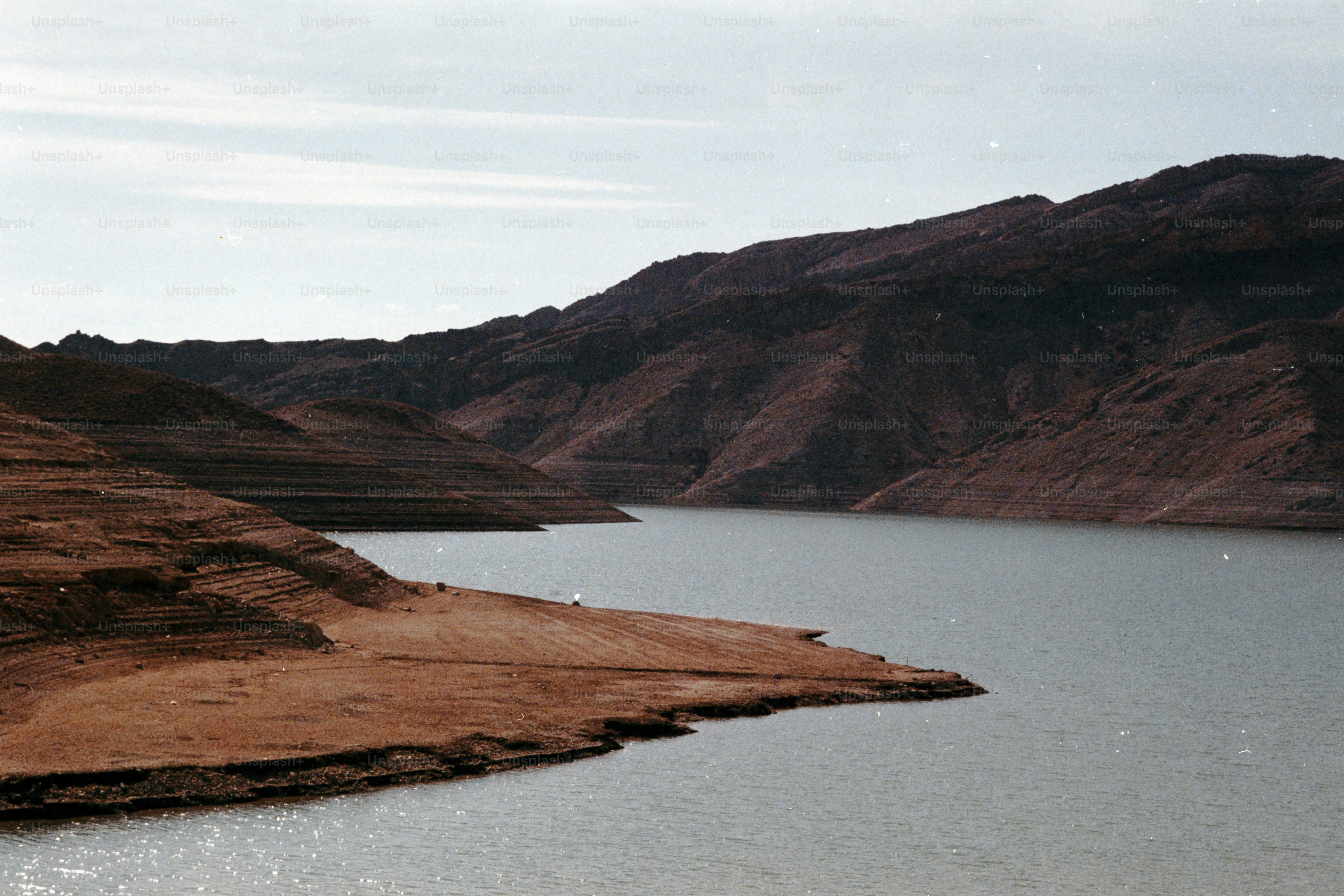 A wide view of a lake with arid hillsides