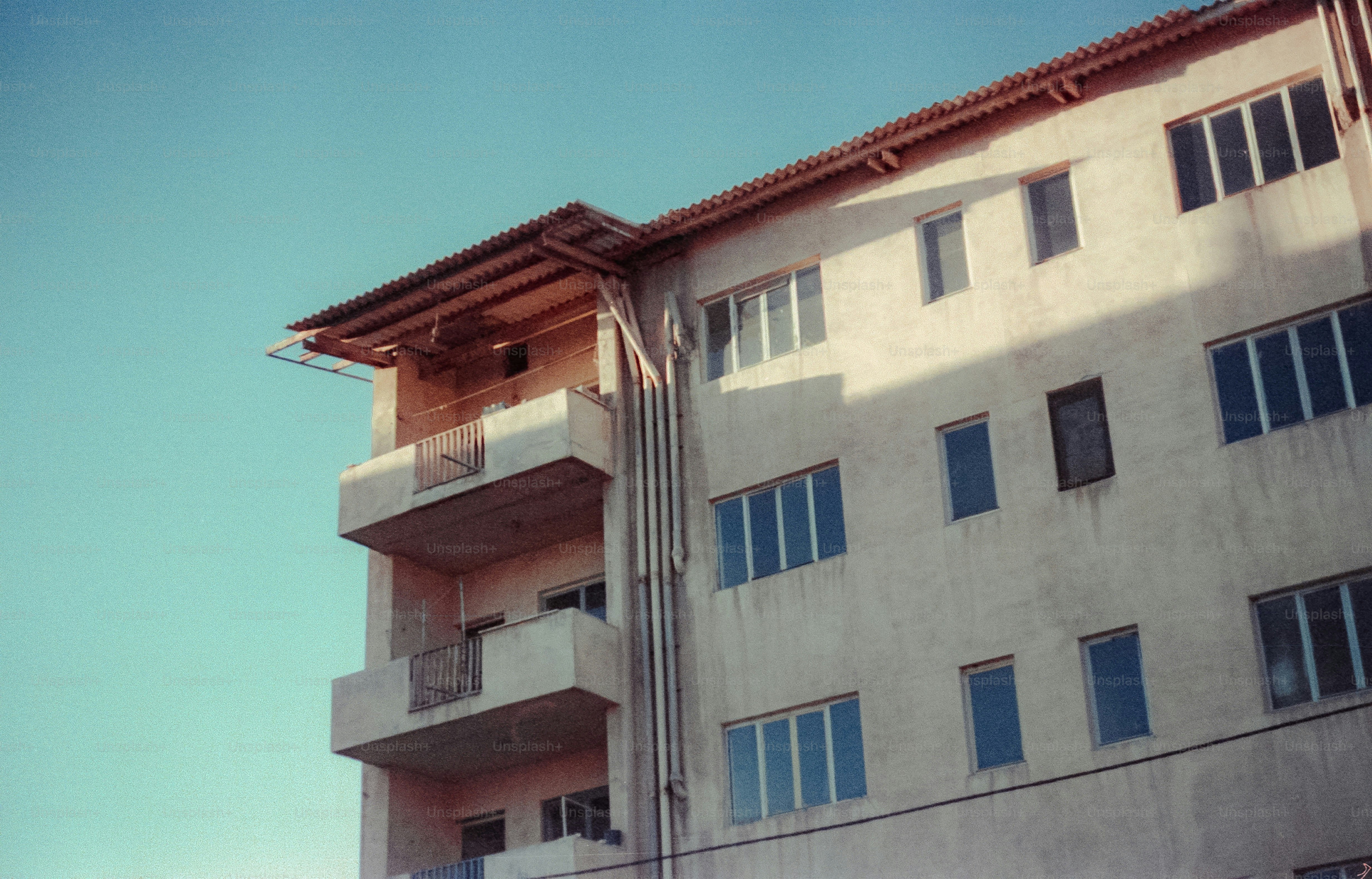 Exterior of a beige apartment building with balconies