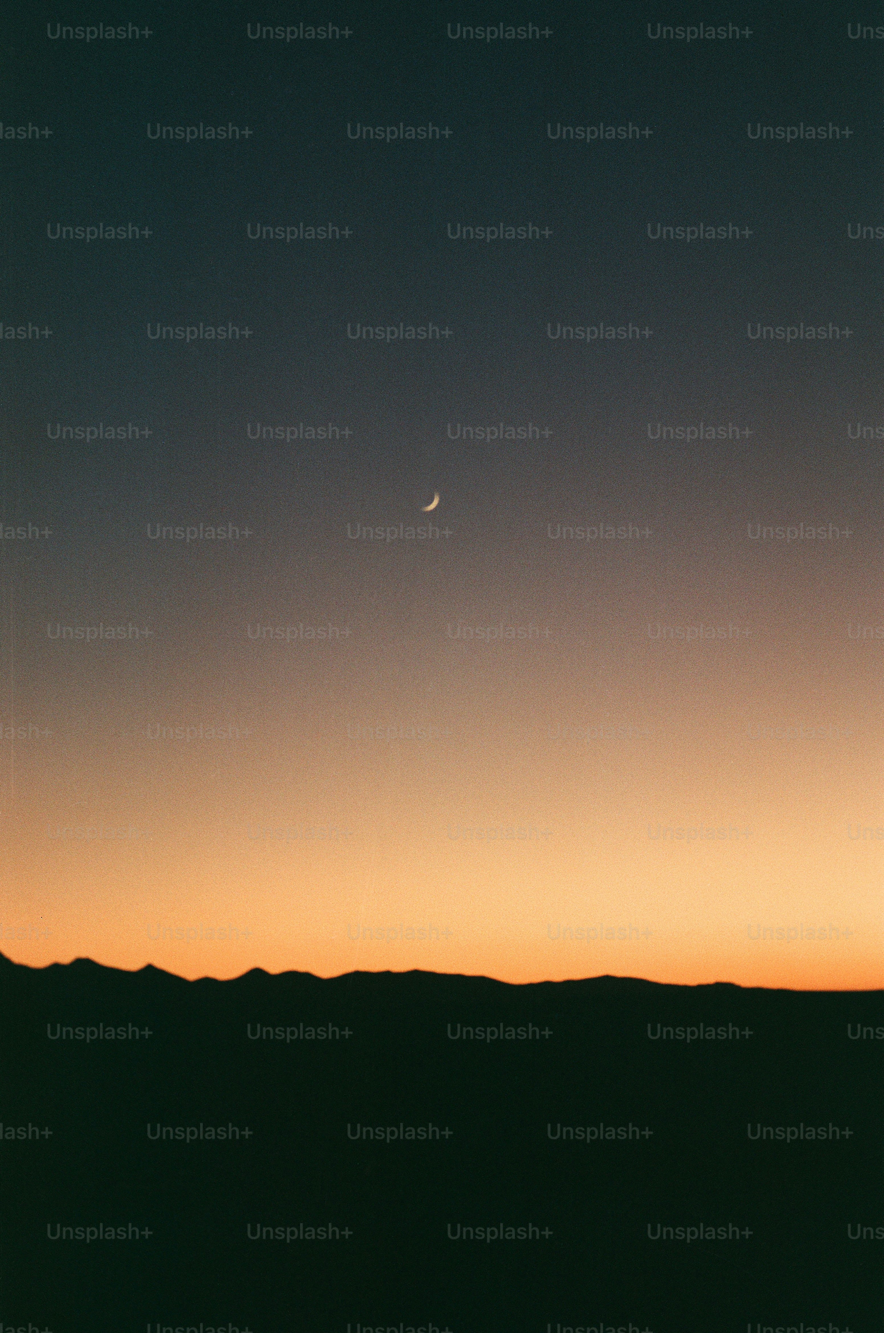Crescent moon in a dusky sky over mountains photo – Sunset Image on ...