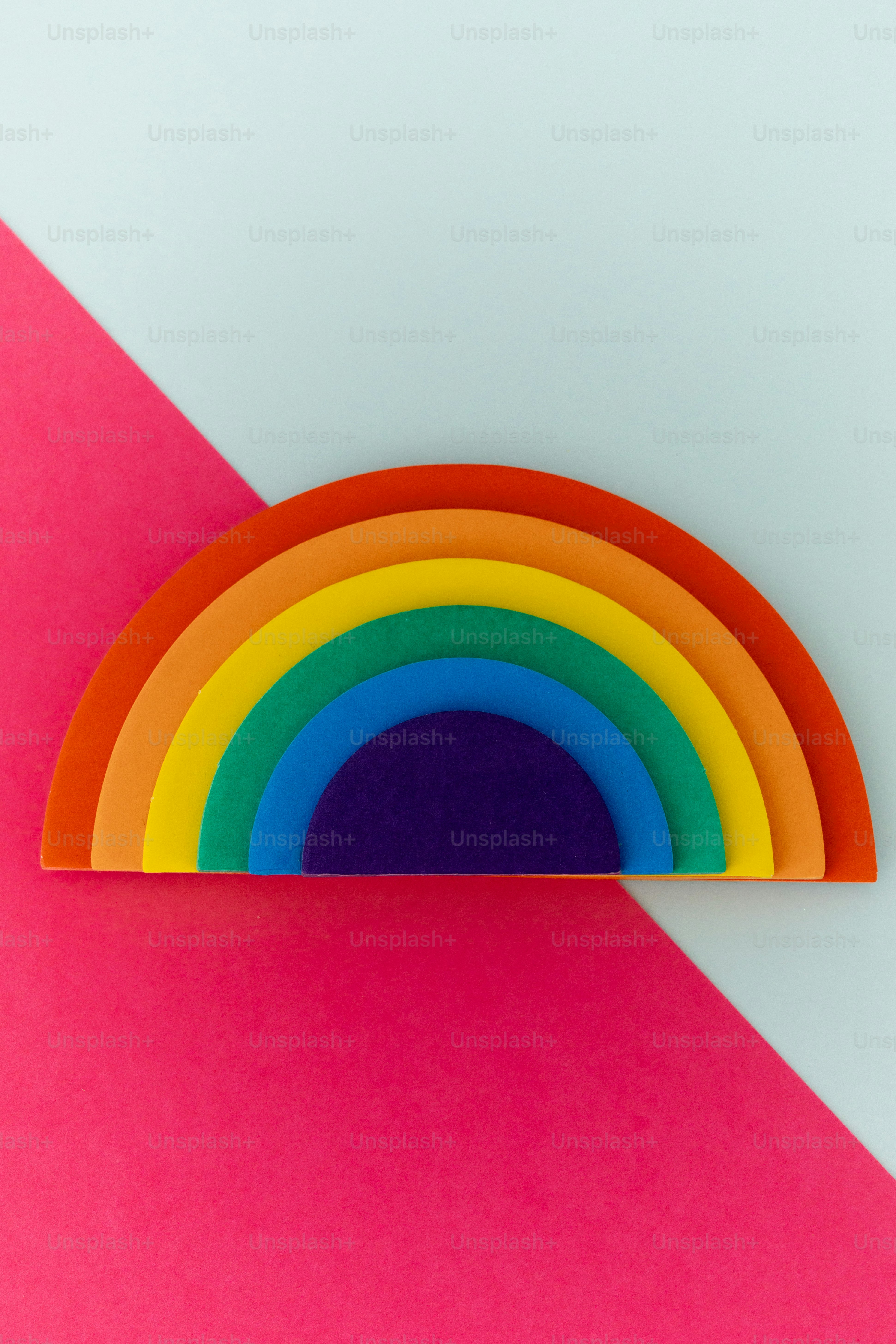 A colorful rainbow layered on a pink and blue background
