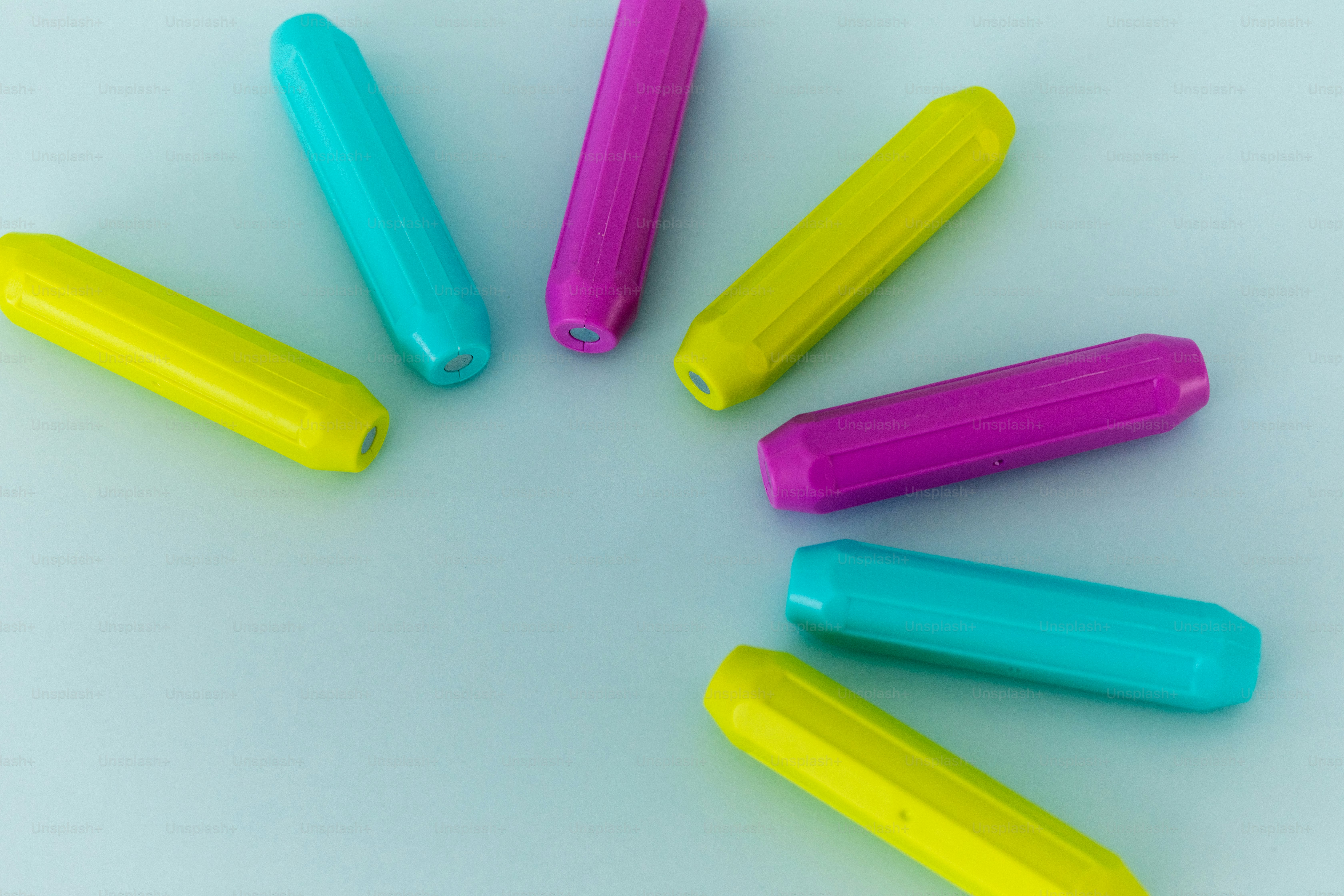 Colorful cylindrical objects arranged in a circle photo – Education ...