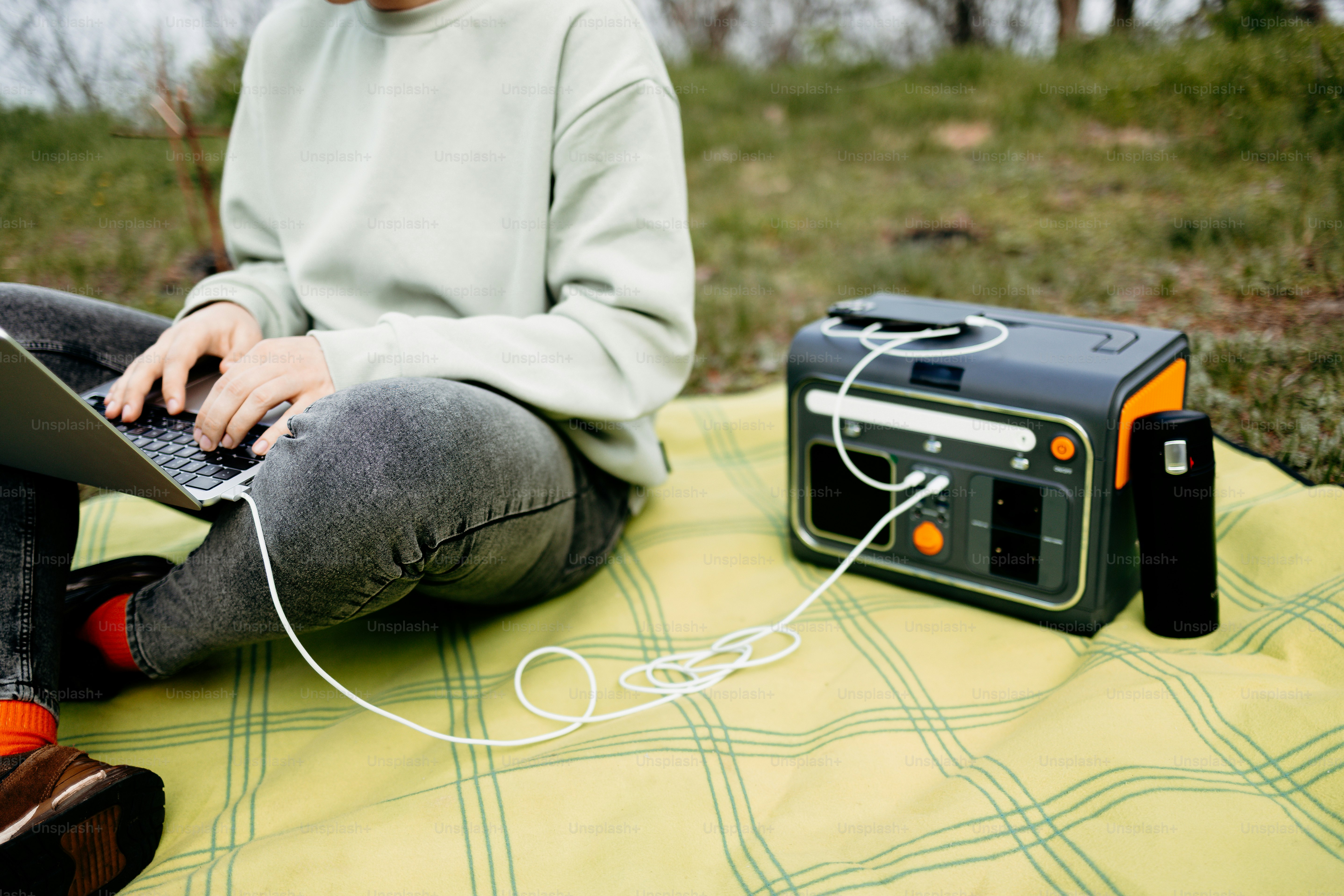 Person using laptop powered by portable generator outdoors photo ...