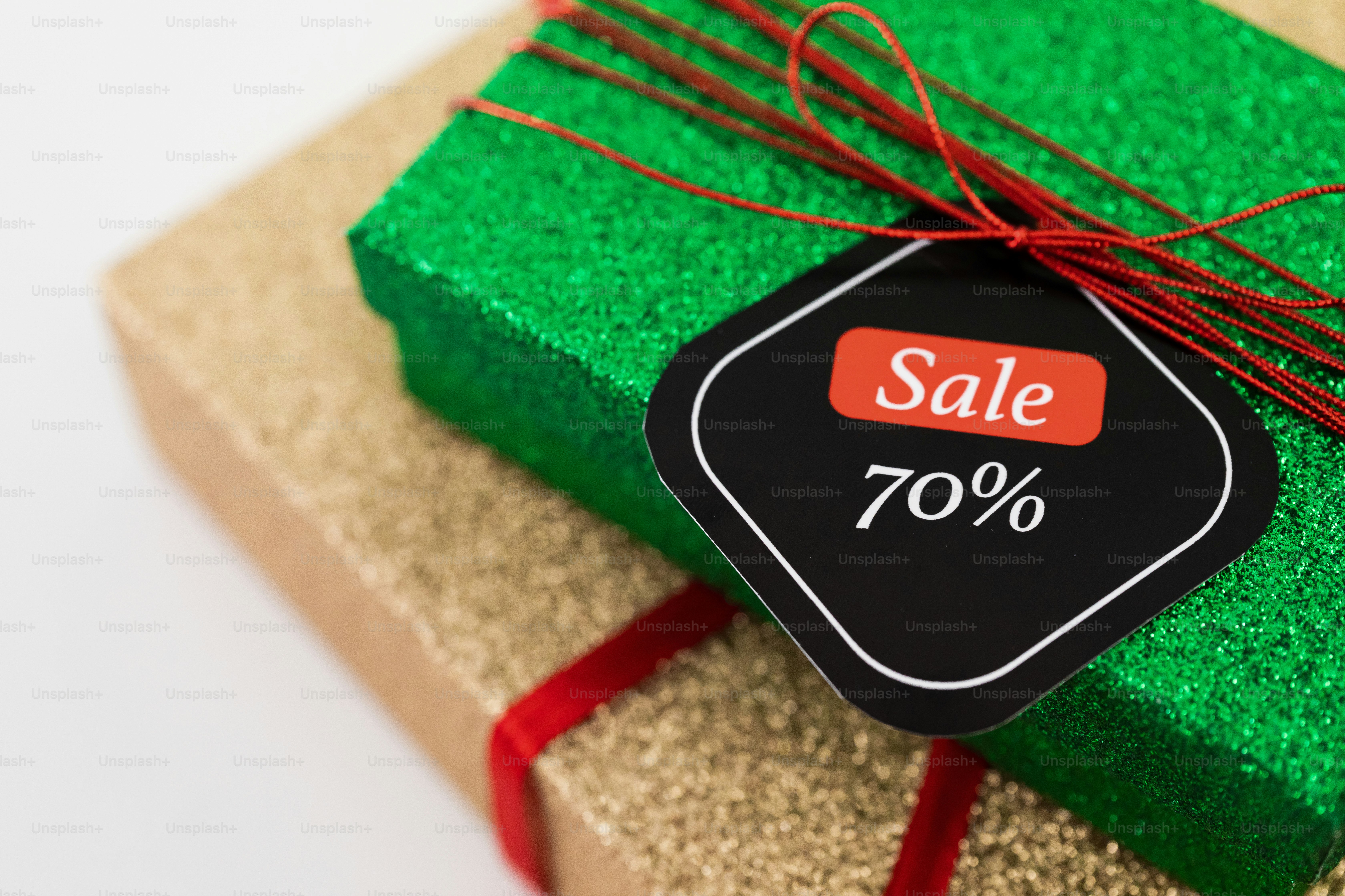 Two glitter gift boxes with a 70% sale tag