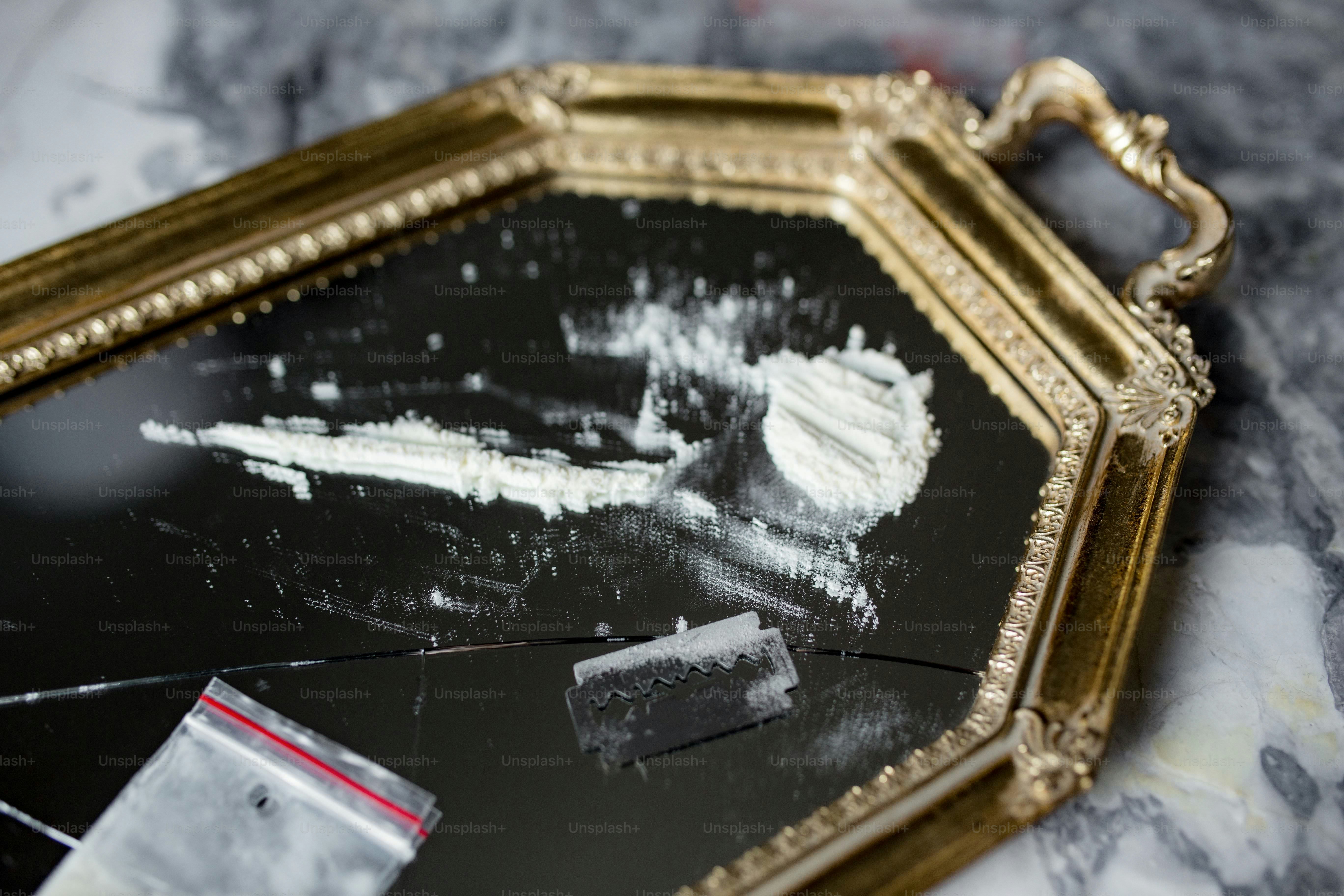 White powder and small bag on golden tray