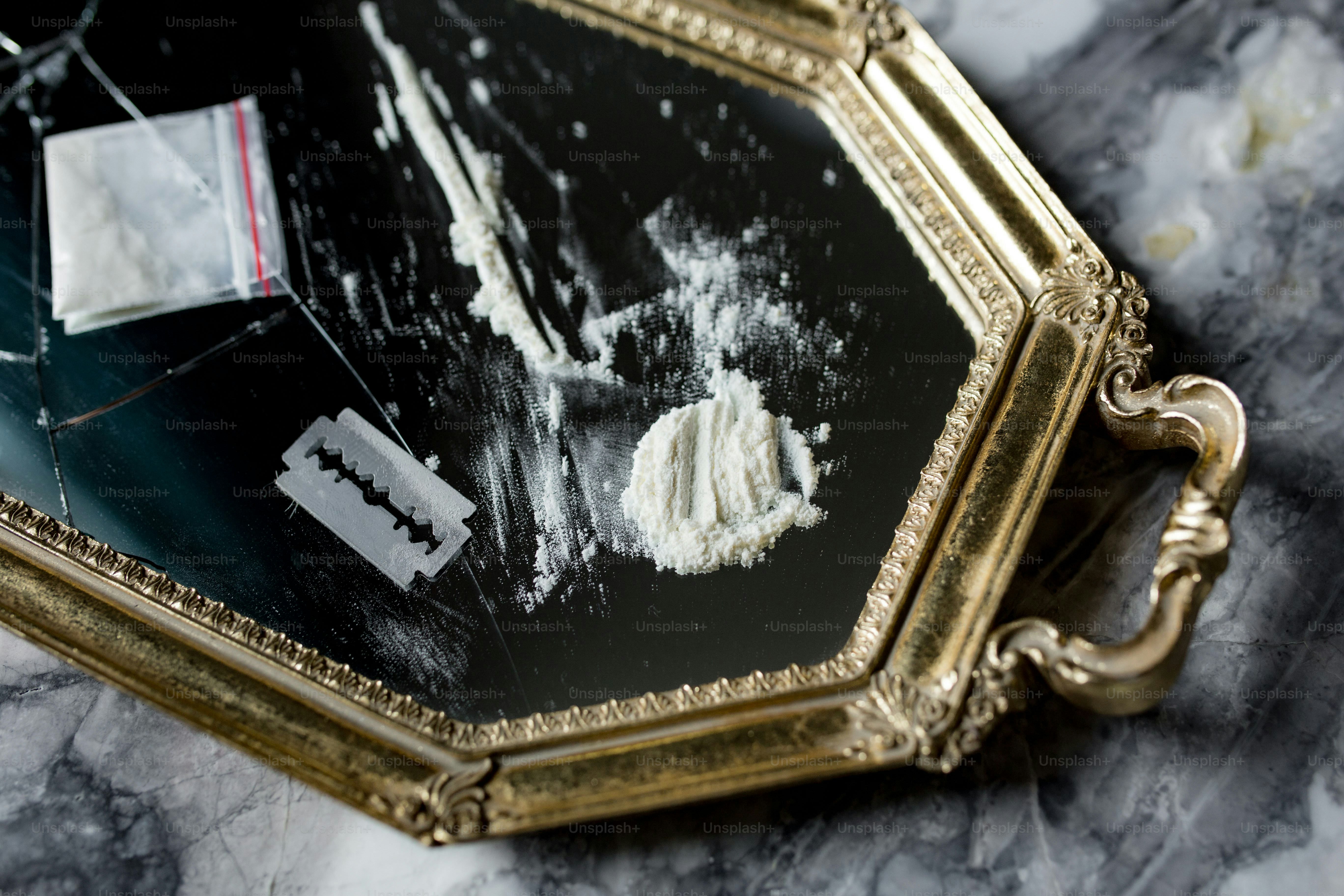 White powder and razor blade on ornate tray
