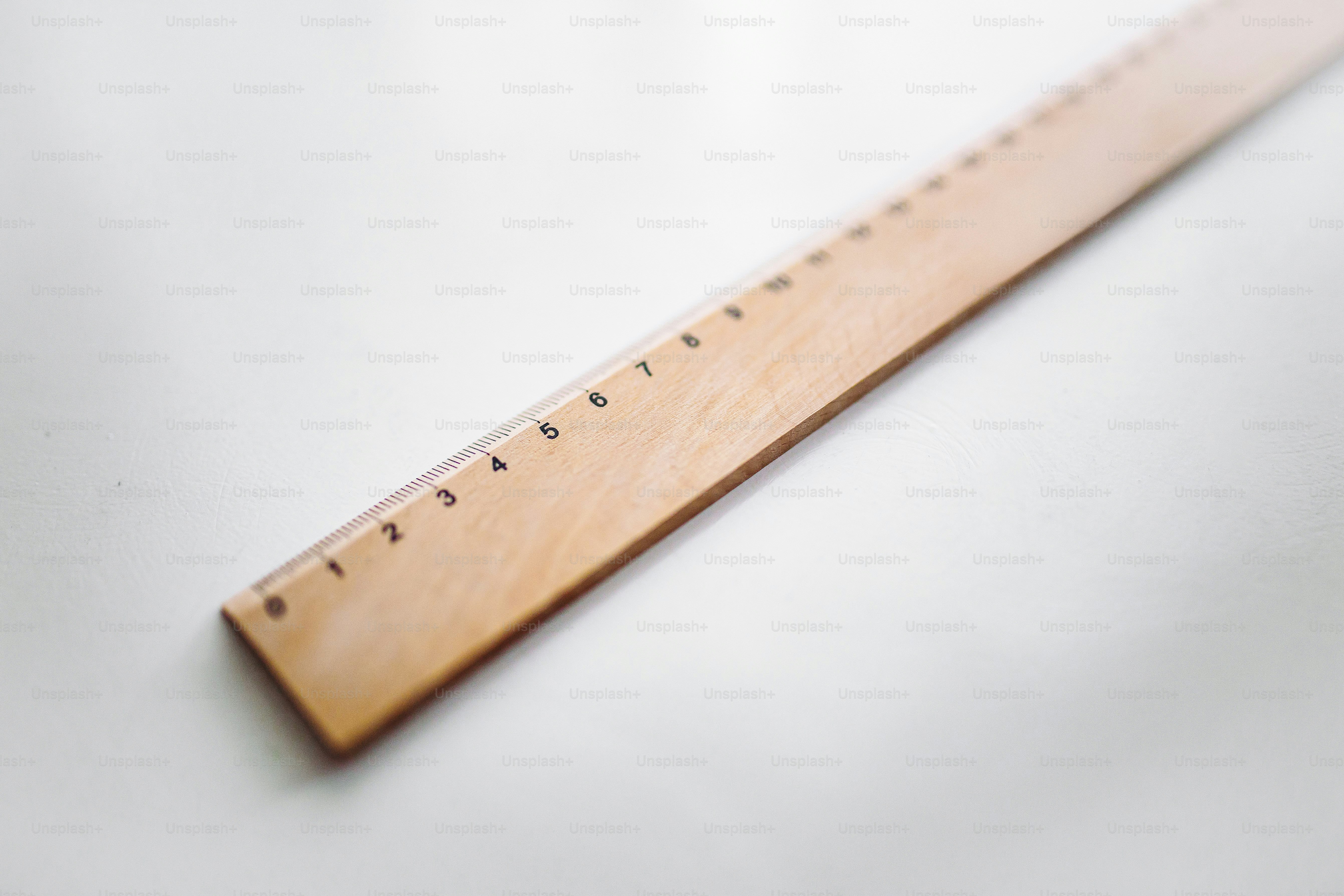 A wooden ruler with black markings on a white background