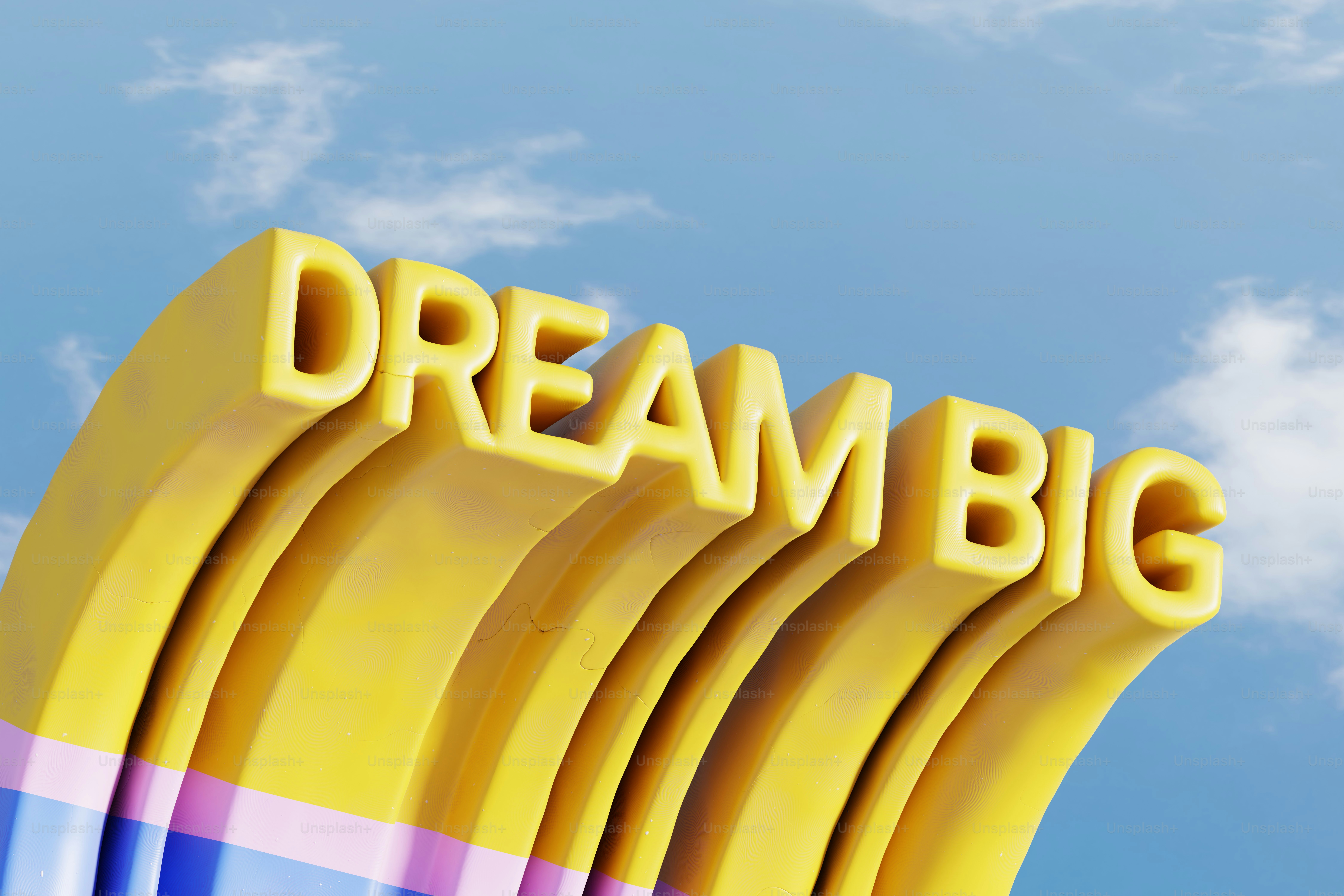 Teks 3D kuning yang mengatakan mimpi besar