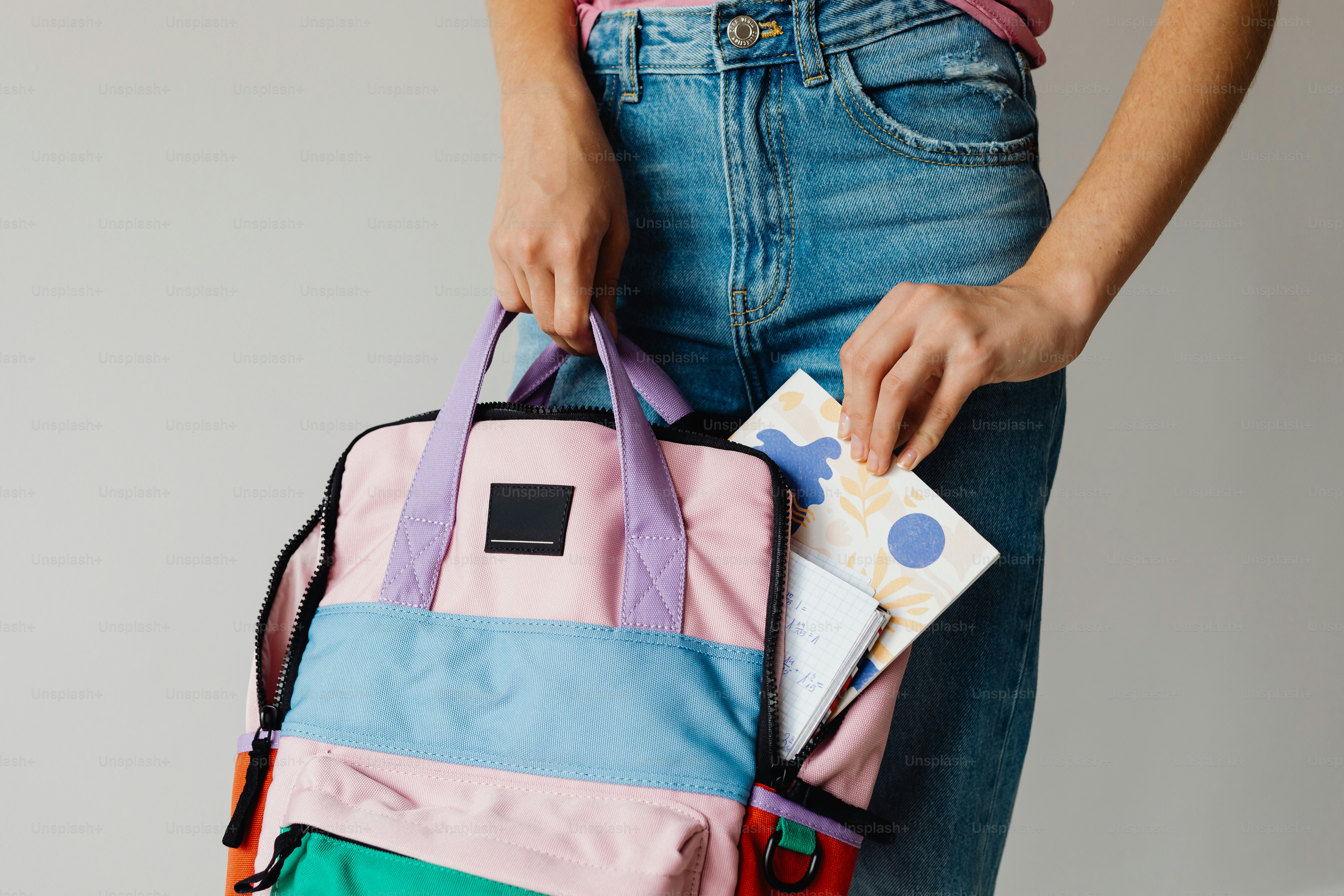 Person putting items into a colorful duffel bag photo – Education Image ...