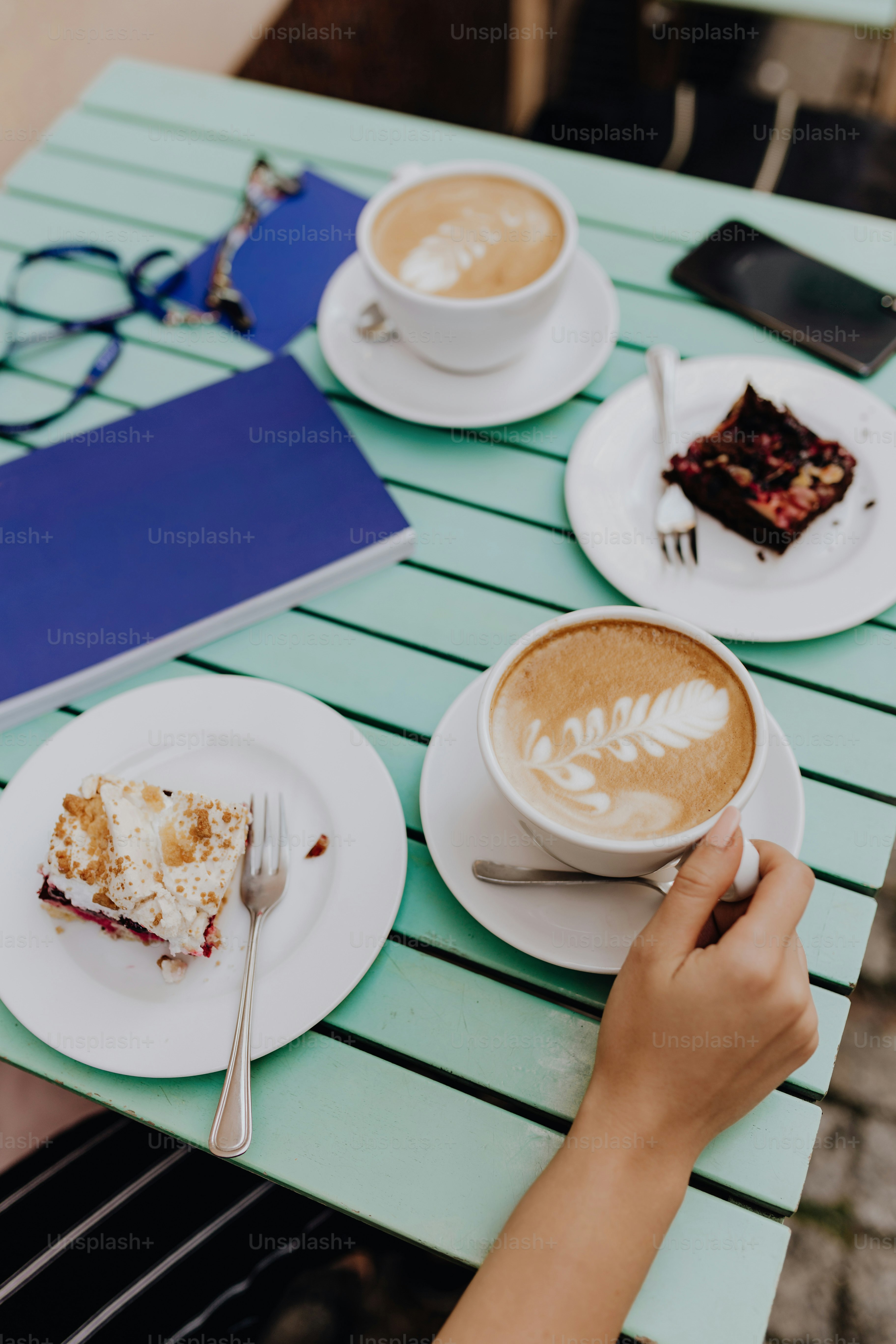 Two coffees and desserts on a table