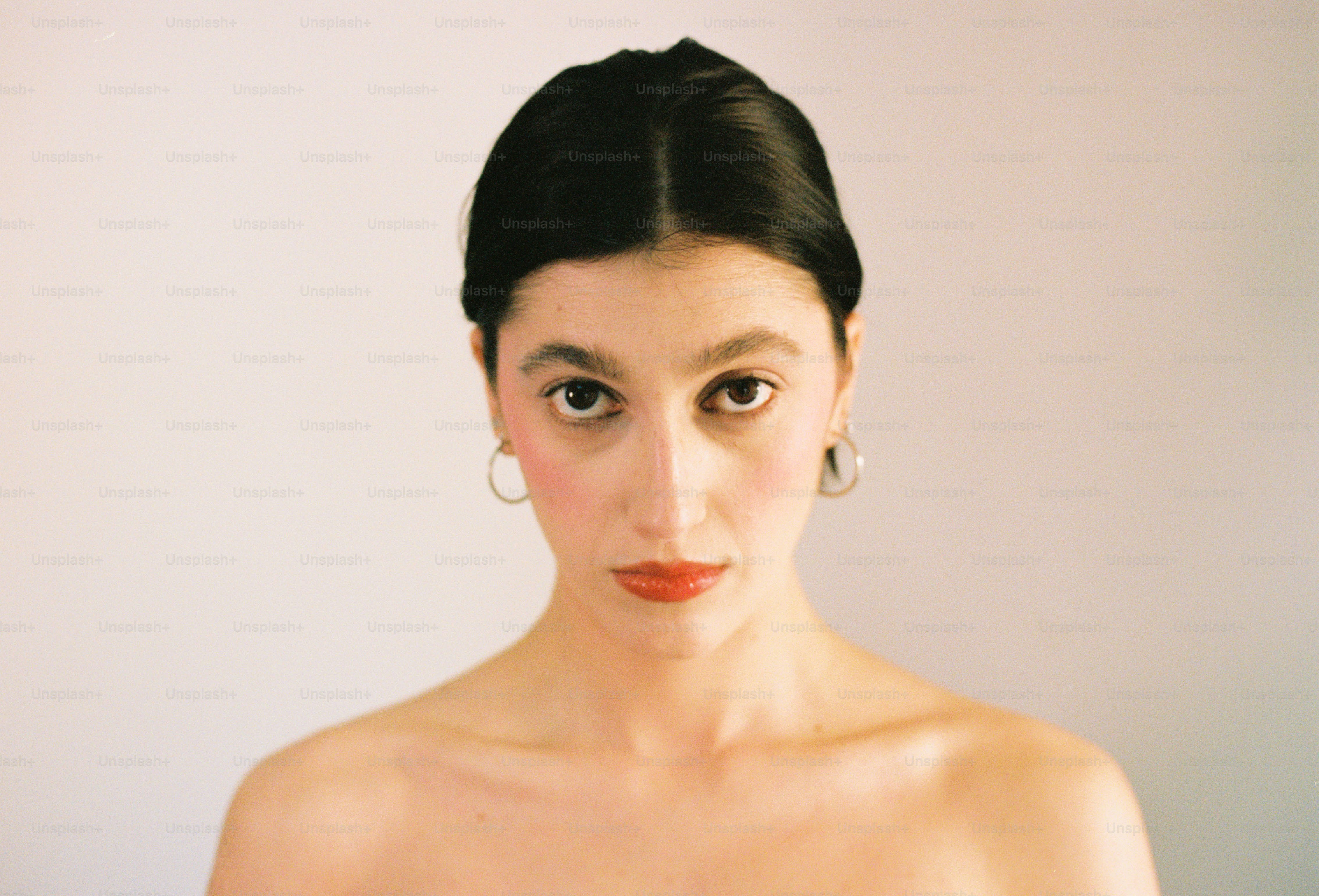 Woman with dark hair and rosy cheeks