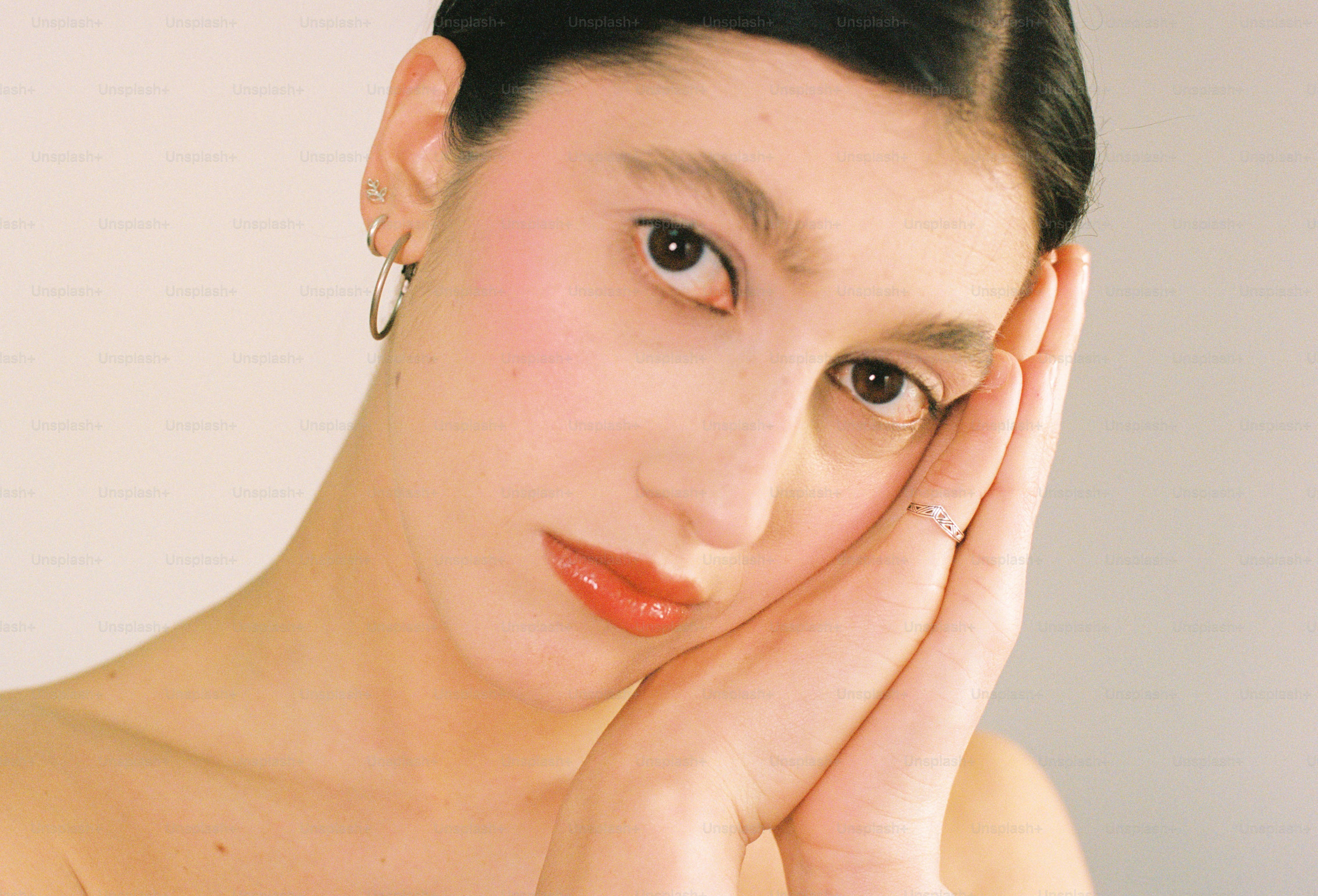A young woman with hands by her face