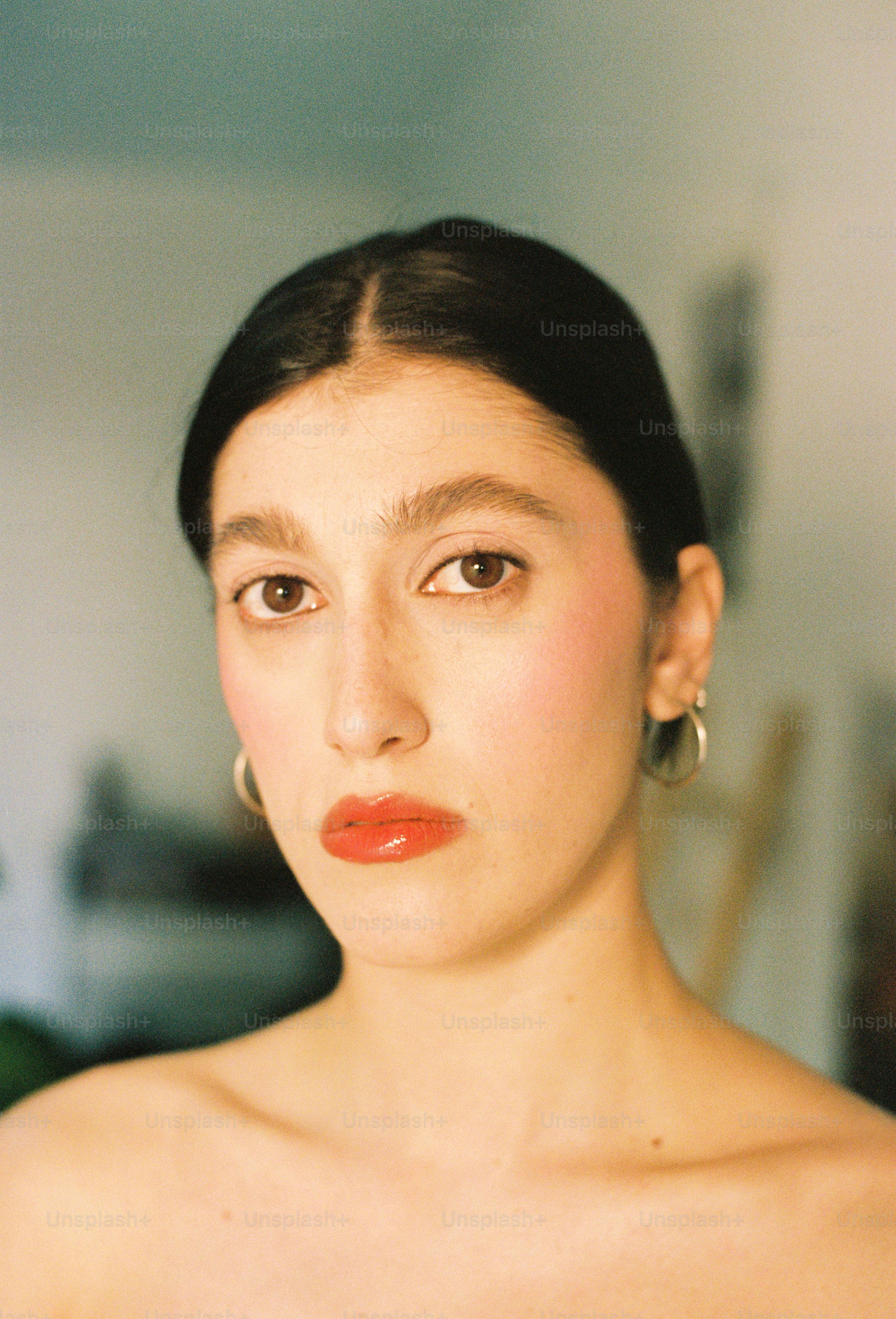 Young woman with red lipstick and blush.