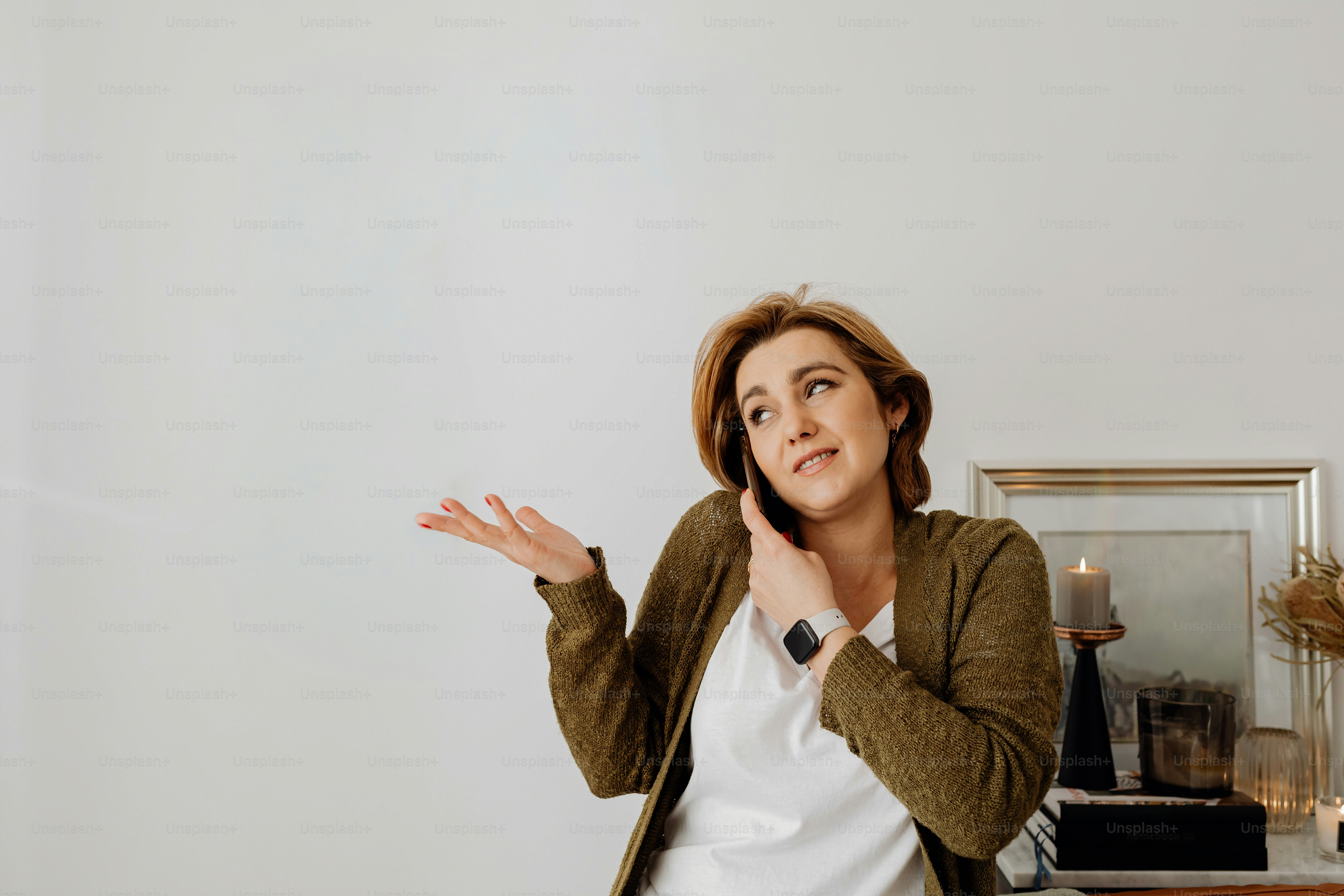Woman talking on a cell phone with hand raised. photo – Woman Image on ...