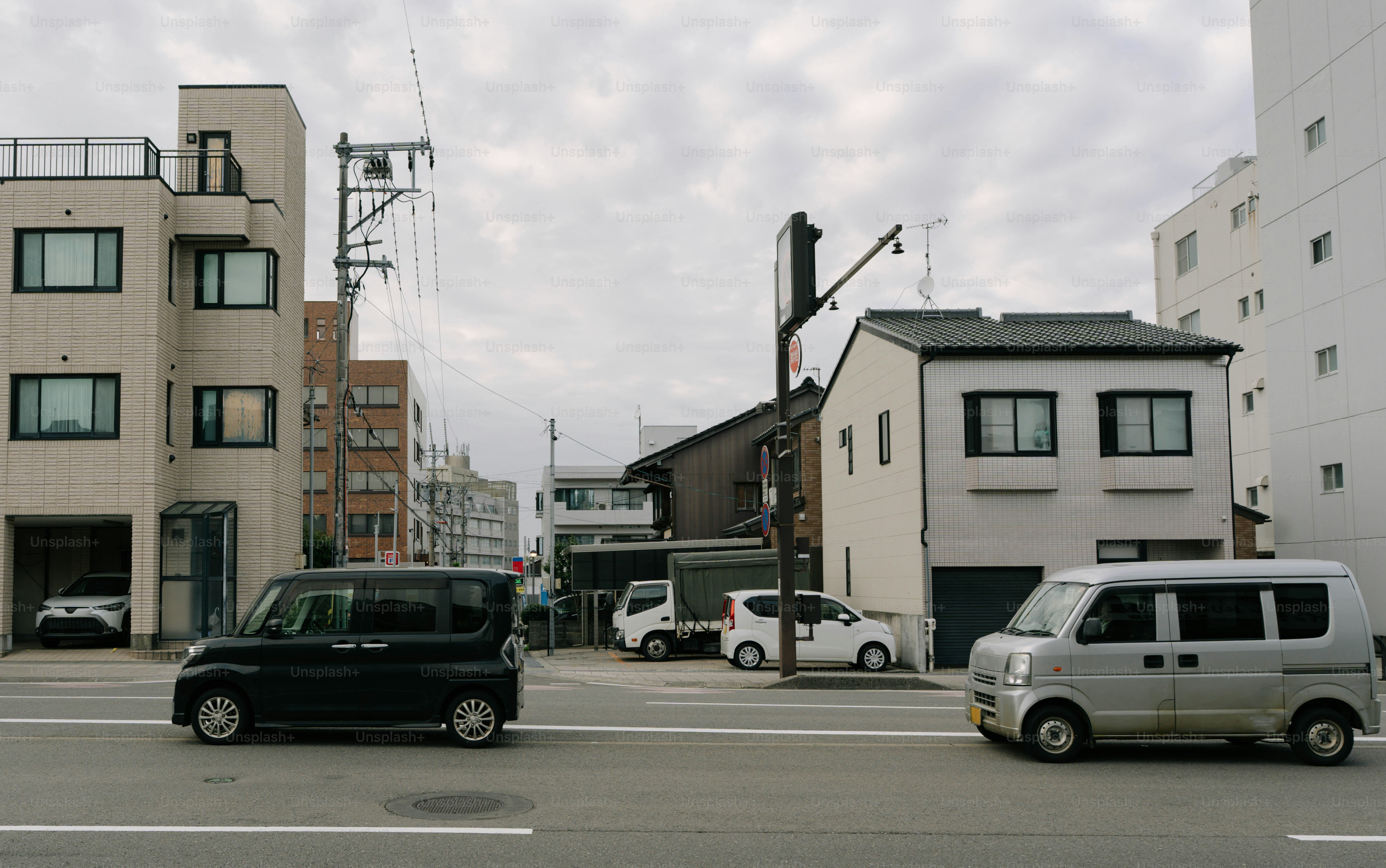 Cars driving on a street in a japanese city.
