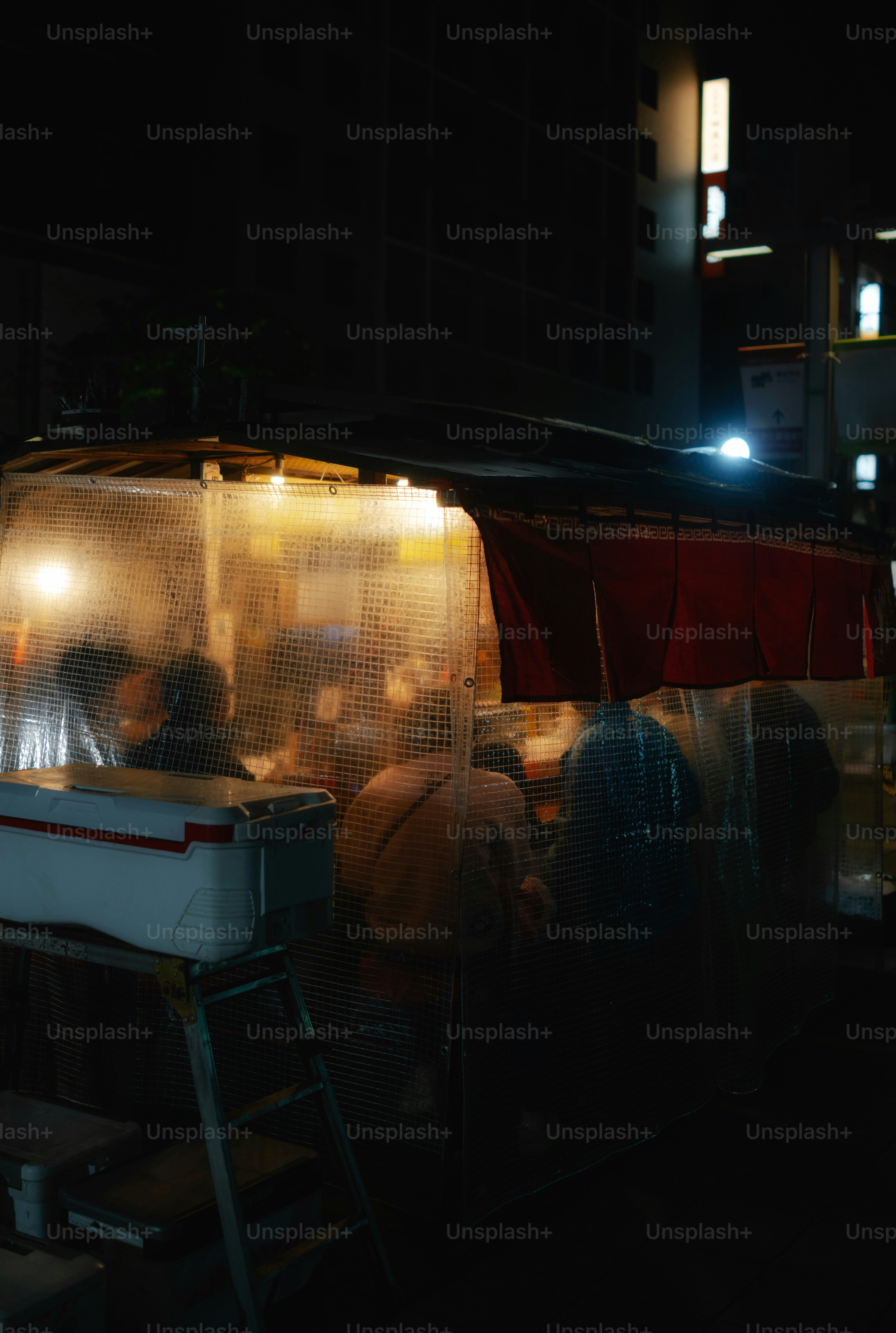 Street food stall at night with people inside
