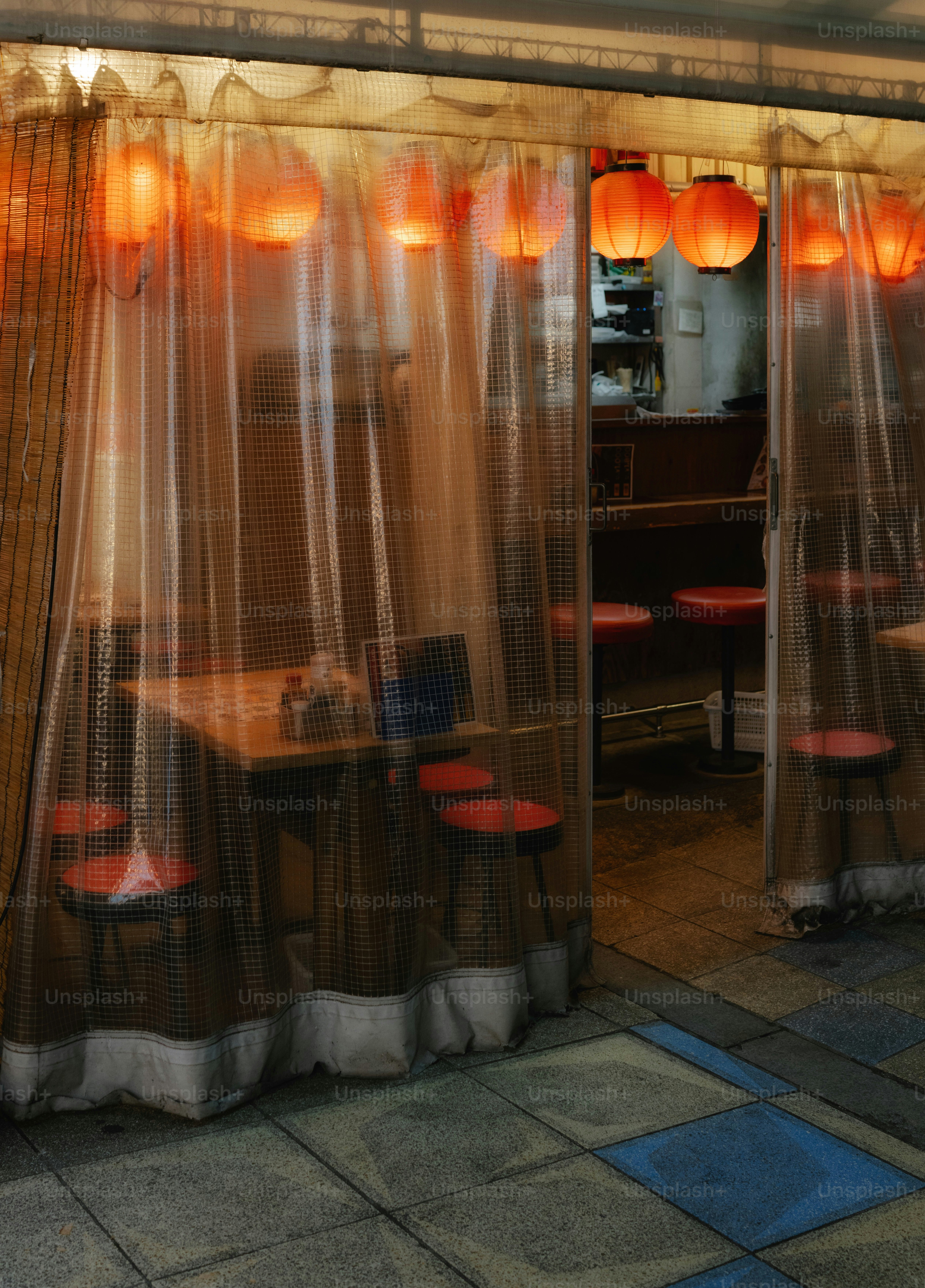 Restaurant entrance with red lanterns and seating